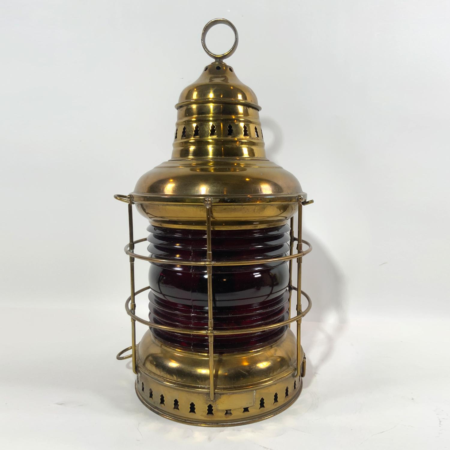 Brass ships anchor lantern with a really rich port wine red fresnel lens by Perkins Marine Lamp Corporation of Brooklyn, New York. Vented top and hoisting ring. Fitted with original burner. Circa 1925. Crack in lens is reflected in price. Please