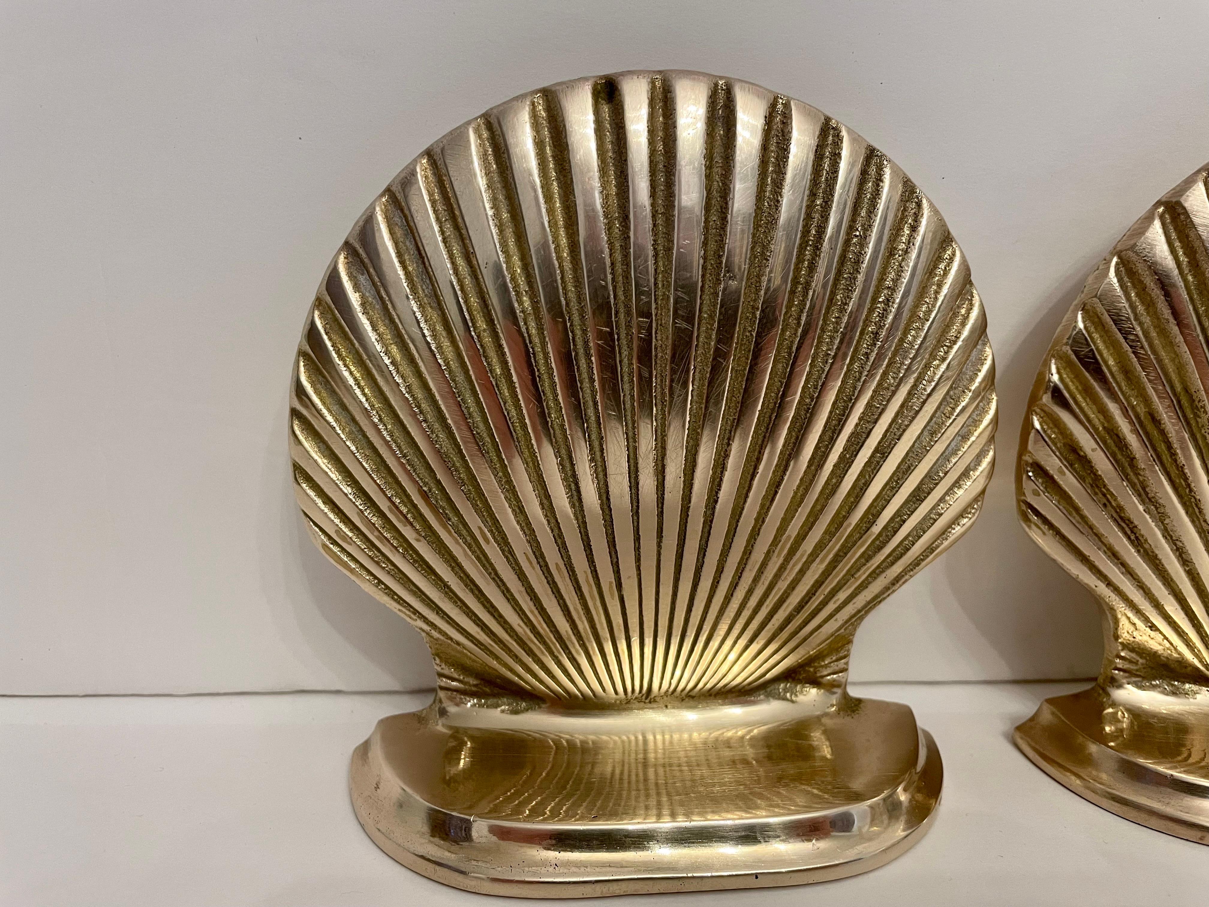 Nice, heavy brass scallop shell bookends. Heavy weight, will hold a nice stack of books. Solid Brass nicely cast with good details. Dark spots are shadows only.