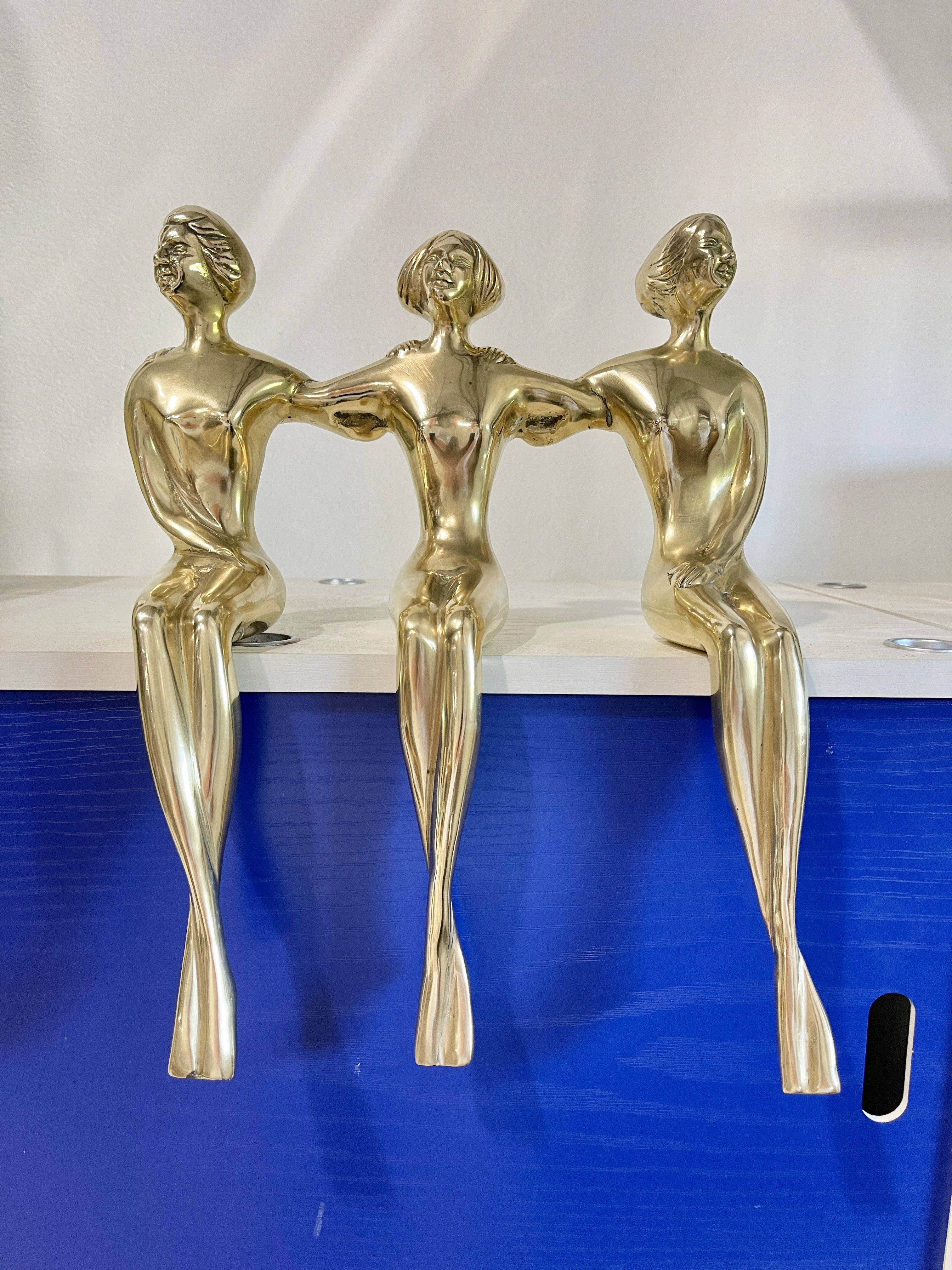 Solid brass sculpture of three women designed as a shelf sitter, by Dolbi-Cashier and produced in South Korea in the late 1970's early 1980's.
The three nude figures are all connected with their arms around one another.
Dolbi Cashier was founded