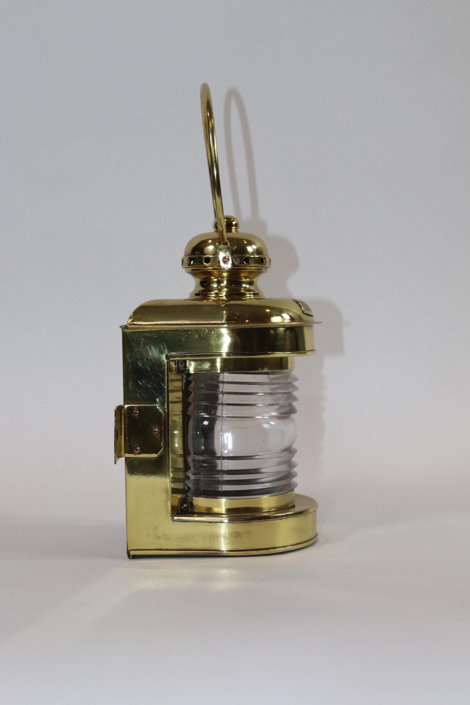 Highly polished and lacquered early 20th century brass boat bow light. With Fresnel lens, loop handle and vented top. No burner or back door. Weight is 3 pounds.