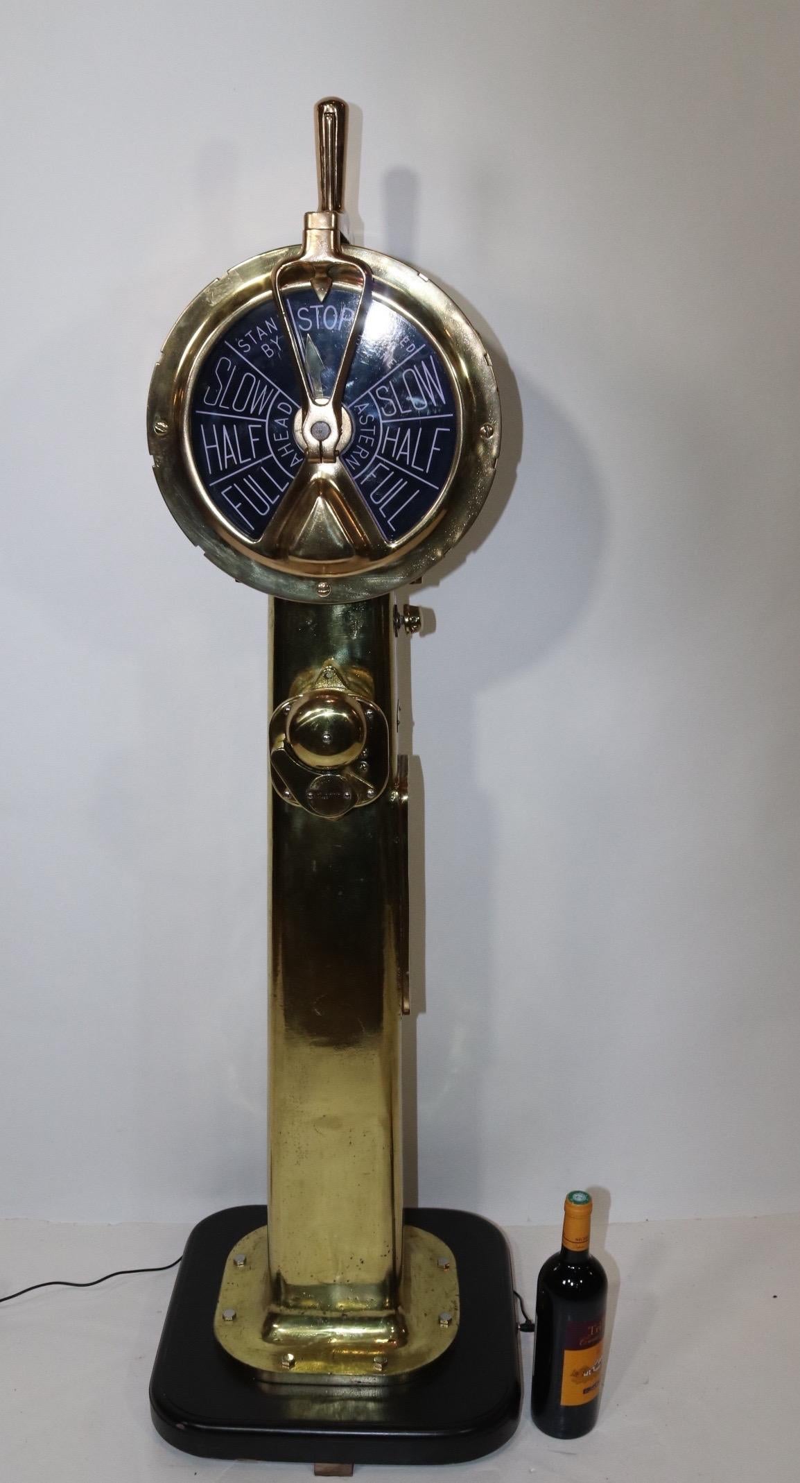 Engine Order Telegraph that has been meticulously polished and lacquered. Faceplates engraved with black background and white letters. Telegraph is mounted to a wood base. Manufactured by Henshel of Amesbury, Massachusetts, circa 1940. We have wired