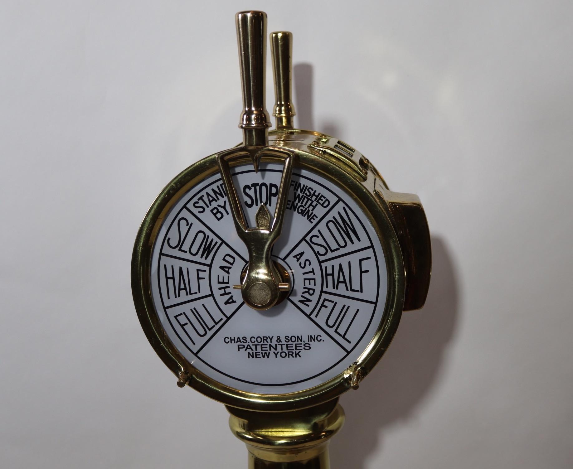 Brass bridge telegraph with command face plates of New York. Highly polished and lacquered. Interior is wired for illumination. Fitted to a thick wood base with rich finish. Very fine condition, circa 1925. Measures: 48