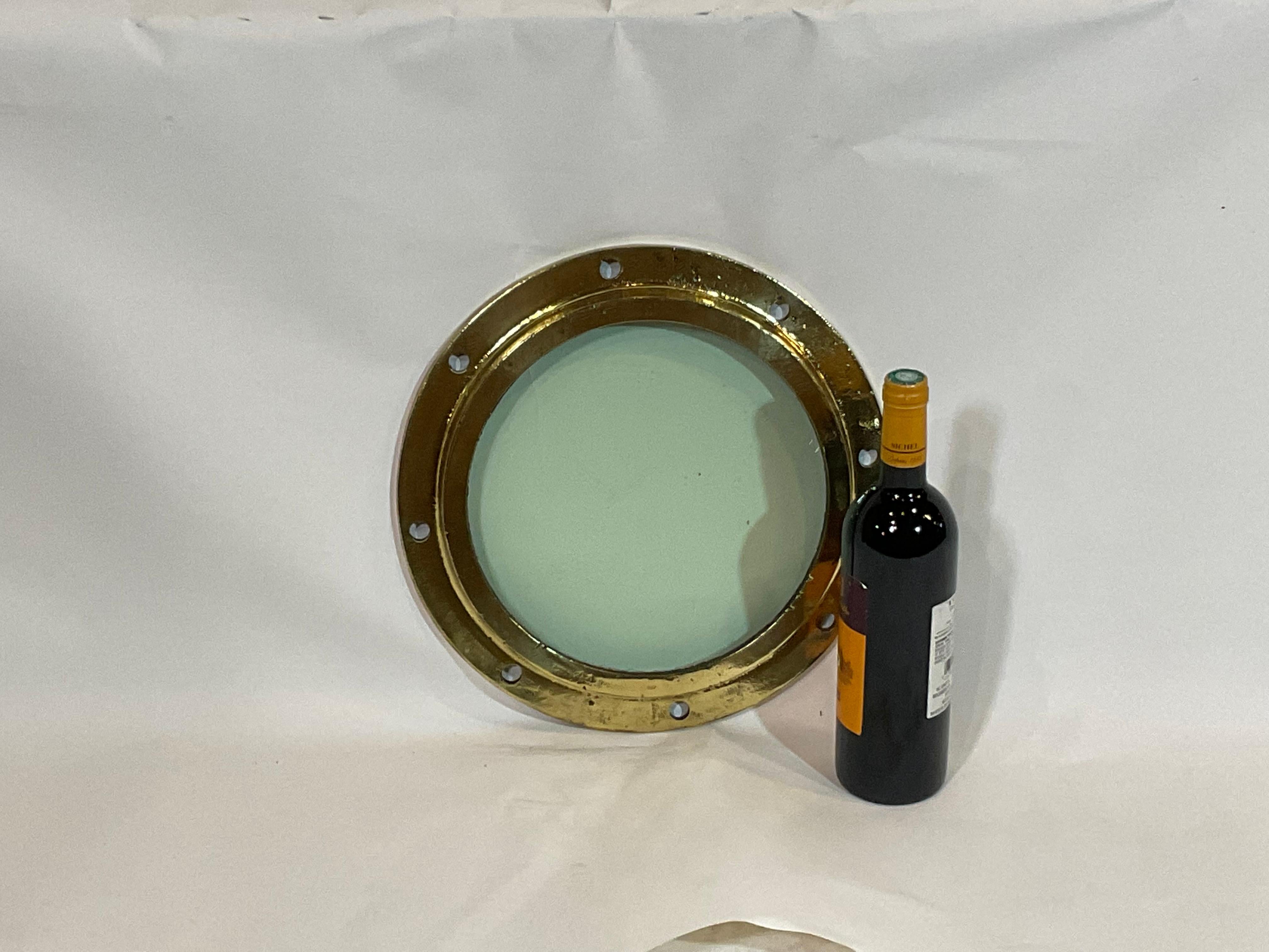 Solid brass highly polished ships portlight with tempered glass. The glass has imperfections from years at sea. This porthole has been polished and lacquered.

Weight: 16 LBS
Overall Dimensions: 2” Height x 14” Diameter
Glass 9 1/2