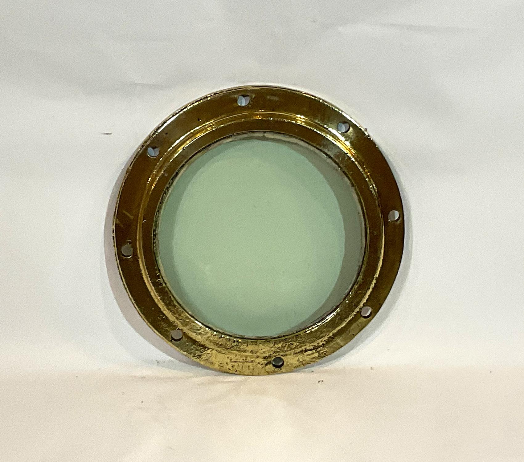 Solid brass ships fixed porthole with tempered glass. The original tempered glass does have imperfections from years at sea. Highly polished boat portlight. This is a worn relic, not as smooth as most of our portholes.

Weight: 16 LBS
Overall