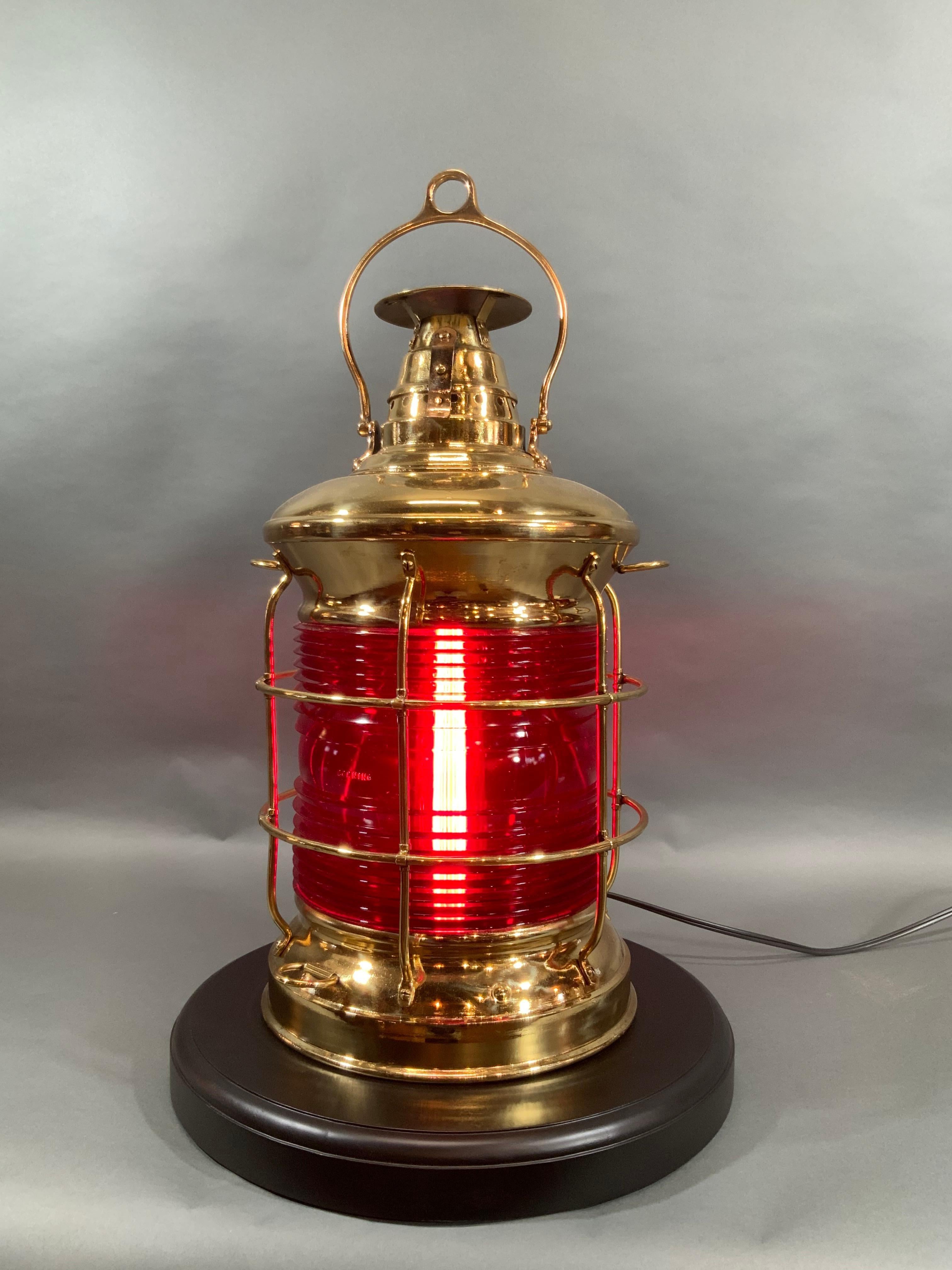 Superb ship's lantern by Lovell with a ruby red lens by Corning. Highest quality ship's lantern with a heavy hoisting handle, vented top, engraved top, thick Fresnel lens, protective bars. Meticulously polished and lacquered to a gleaming finish.