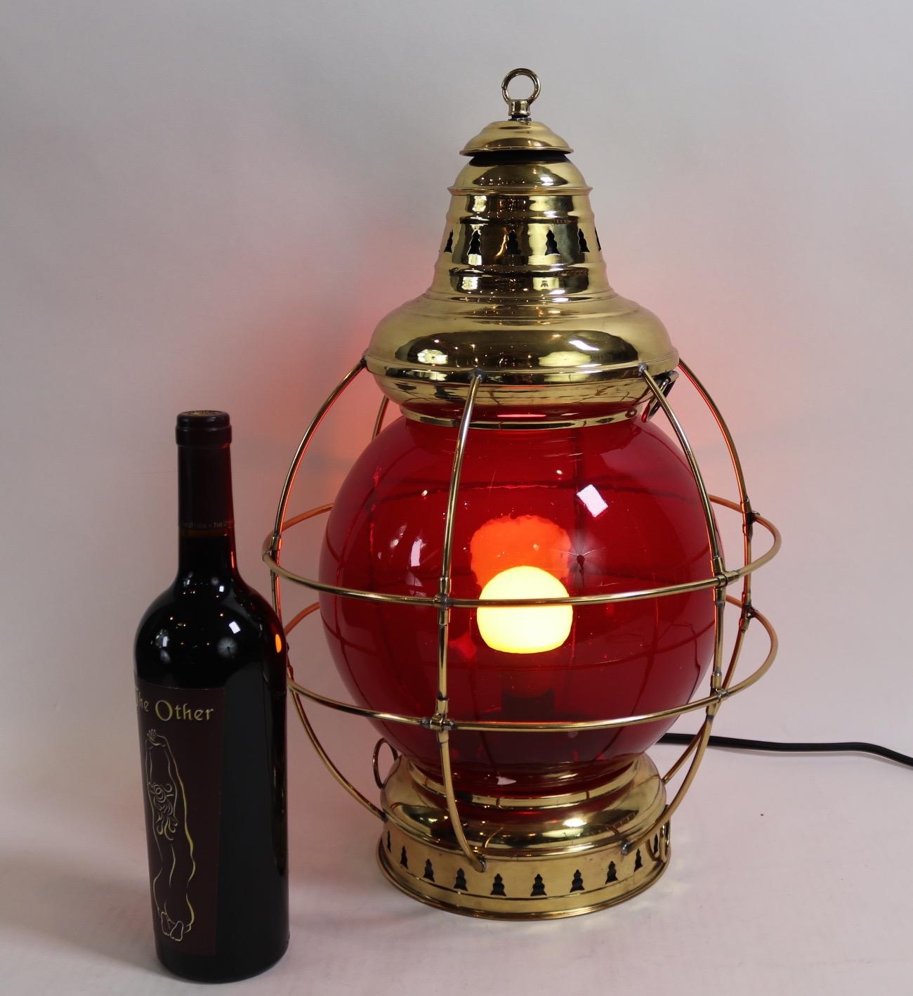 Highly polished ships onion lantern with lacquered finish. Rich red ten inch lens marked Perkins surrounded by a protective cage. With vented top and bottom. Wired for home display. Weight is 7 pounds.