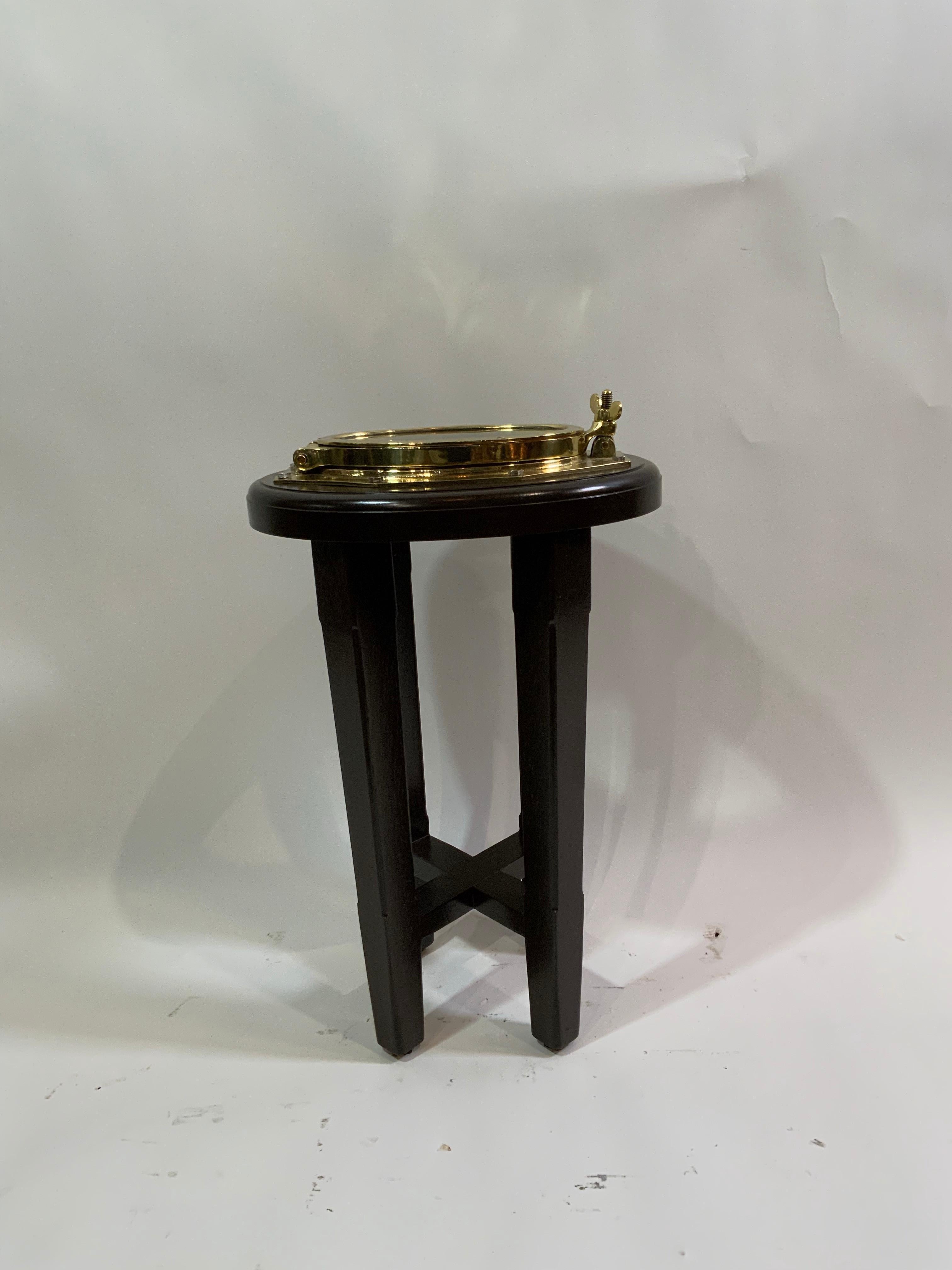 Mid-20th Century Solid Brass Ships Porthole Mounted To A Mahogany Table Base For Sale