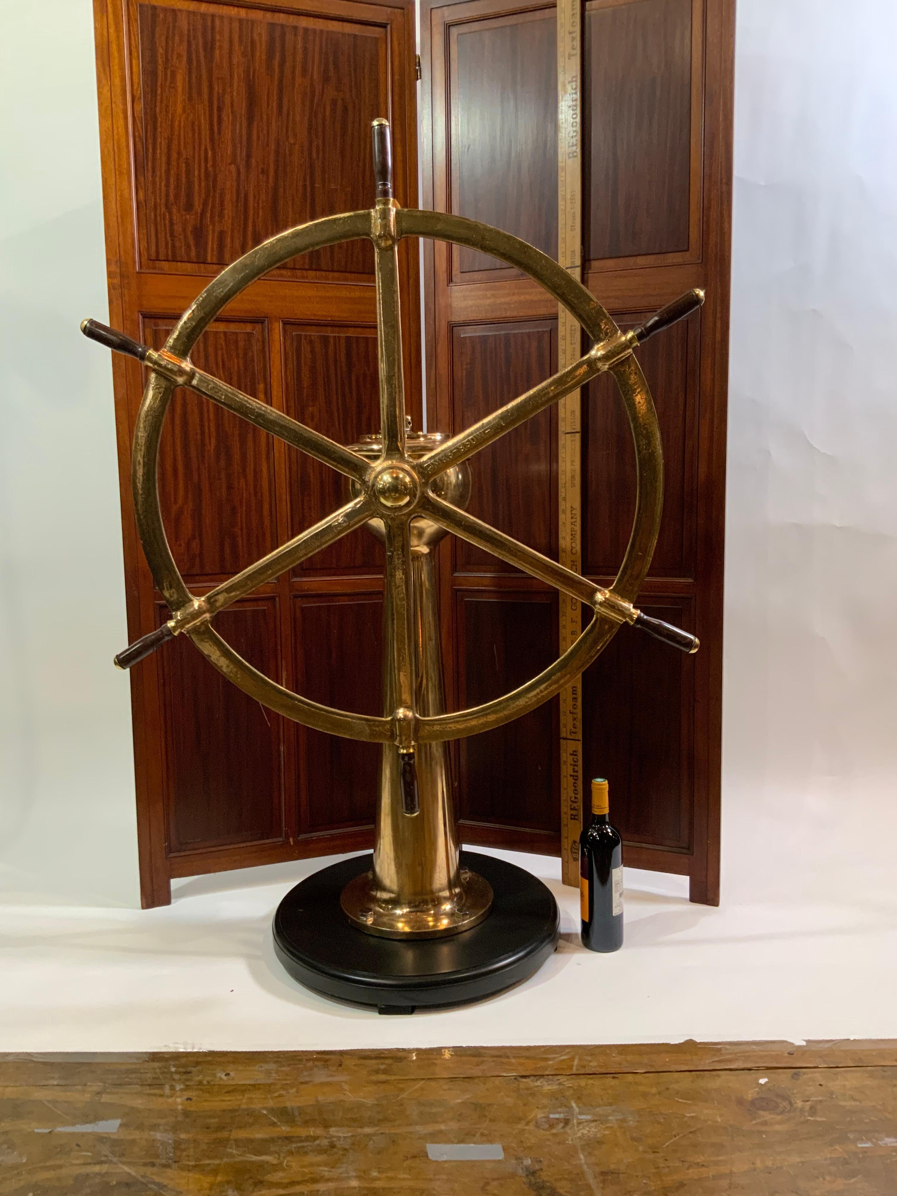 Highly polished and lacquered six spoke ships wheel mounted on its original geared pedestal. Fitted with wood spoke handles and mounted to a thick mahogany base. Weighs 145 pounds. Dimensions are 57 tall and wheel is 41 inch diameter. Price $5295.