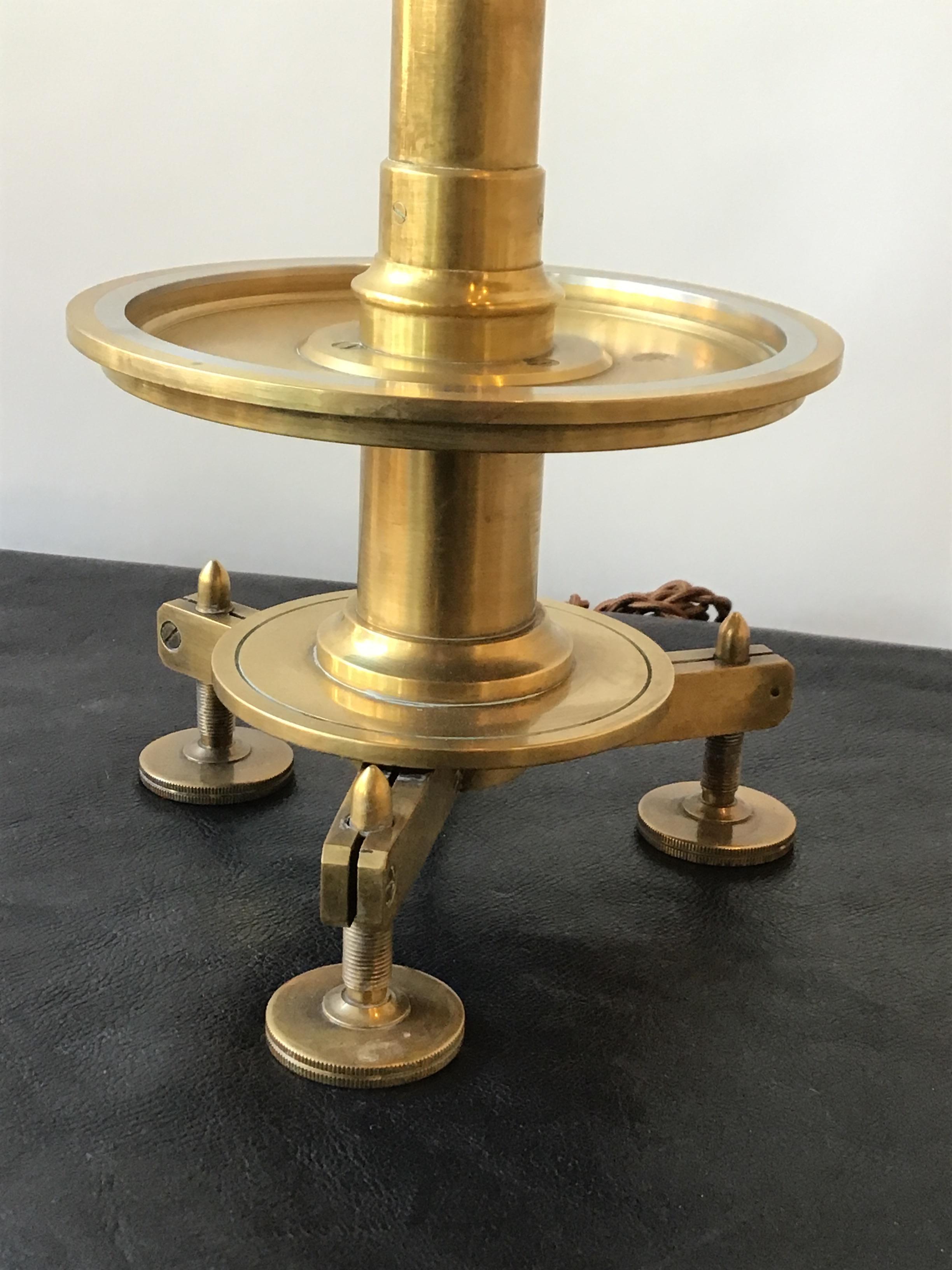 Solid brass, great quality table lamp. Looks like a surveyors instrument. 22” high.