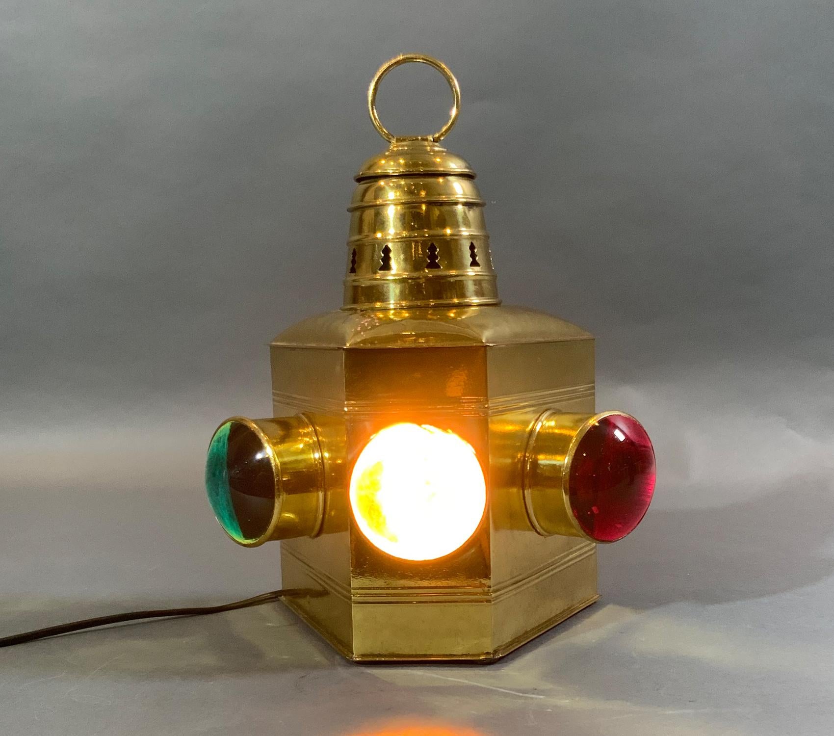 Polished brass boat lantern with three bulls eye lenses, red, green and clear. Highly polished. Fitted with a fresh socket for home use. Hinged door to rear.

Weight: 7 lbs
Overall Dimensions: 12