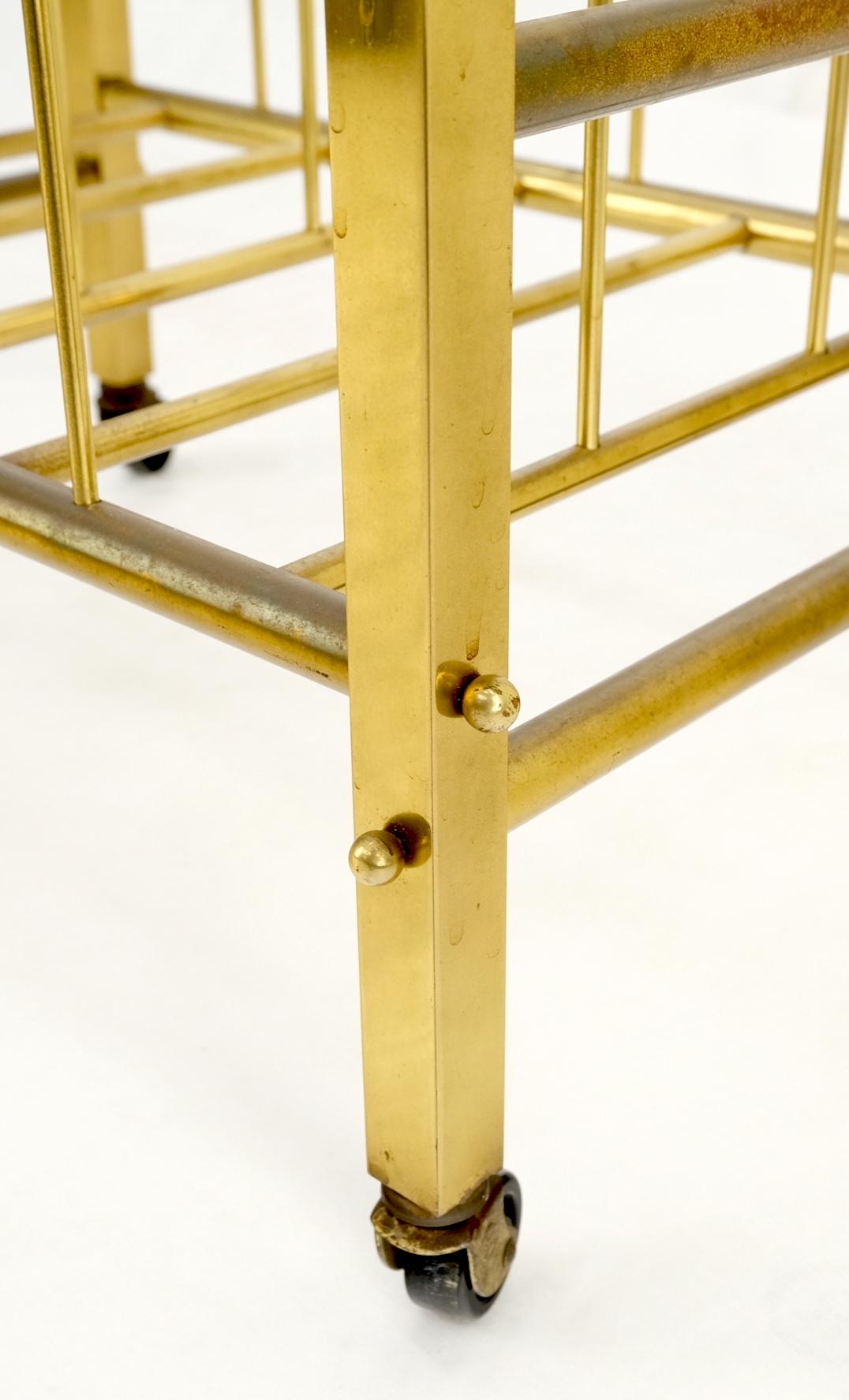 Solid brass tube design Mid-Century Modern magazine stand on casters.