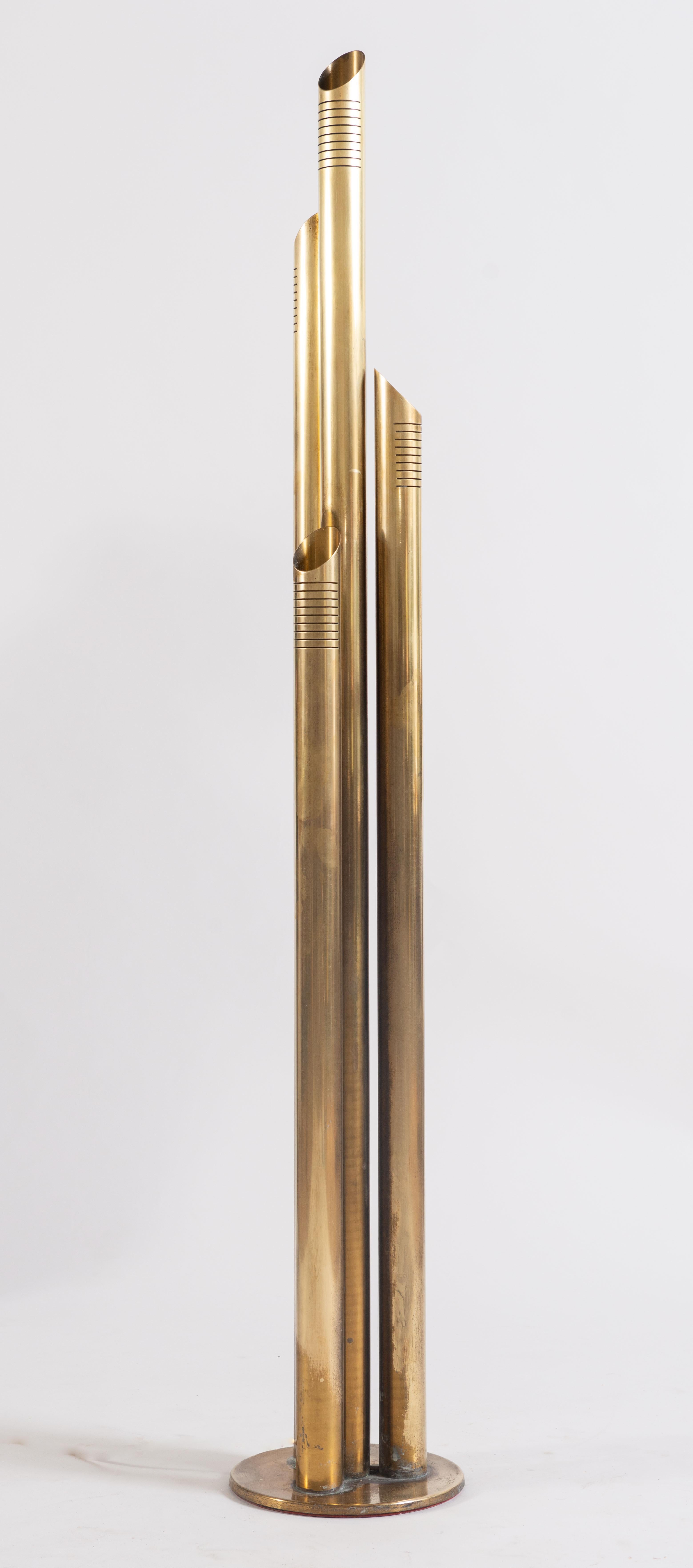 Nearly six-foot tall solid brass floor lamp designed by R. Fontana, circa 1970. Four brass tubes extend from the circular base and end in varying heights. Slits at the top of each tube allow light to pass through in addition to the top angled