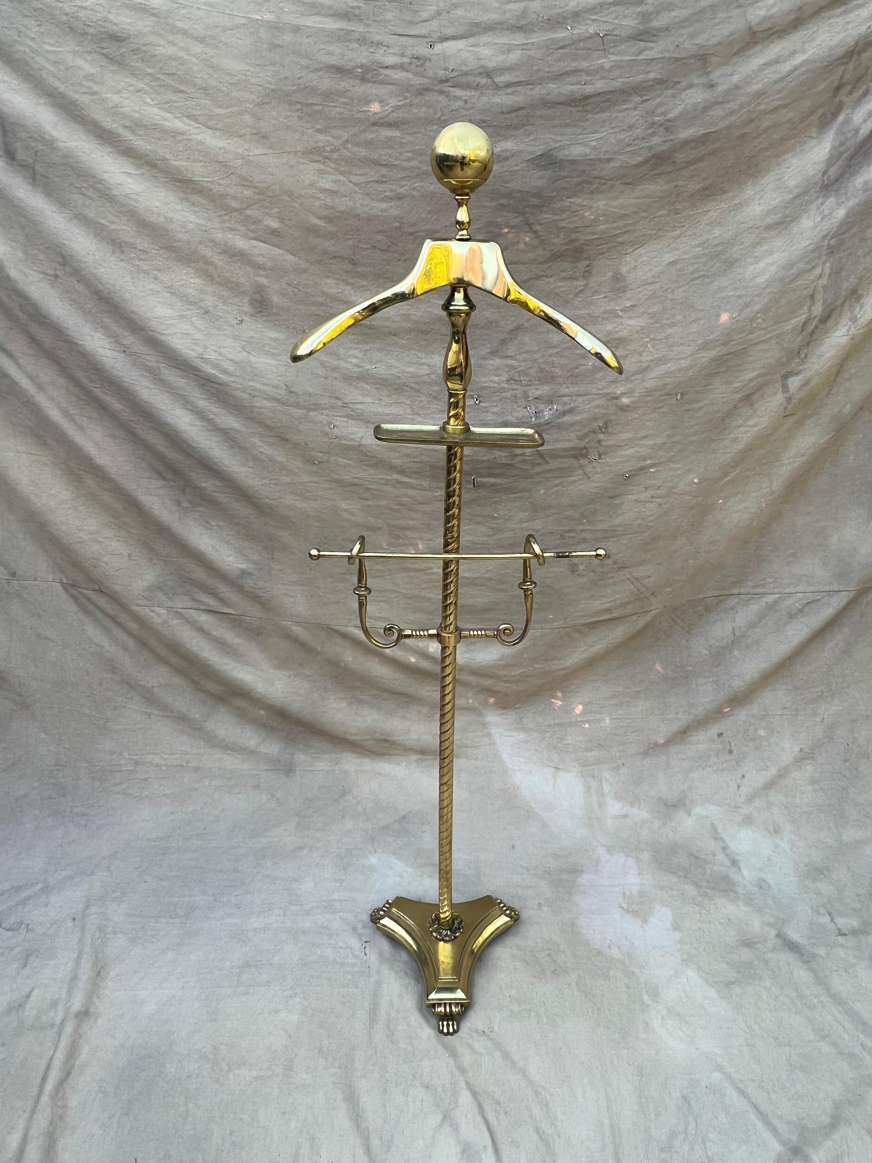 A wonderful brass valet with a unique and heavy base. We have never seen one with a more solid base with lion feet - very nice. Holds a jacket, pants and has the necessary platform for change, wallet, keys, etc. 

A compliment to any dressing