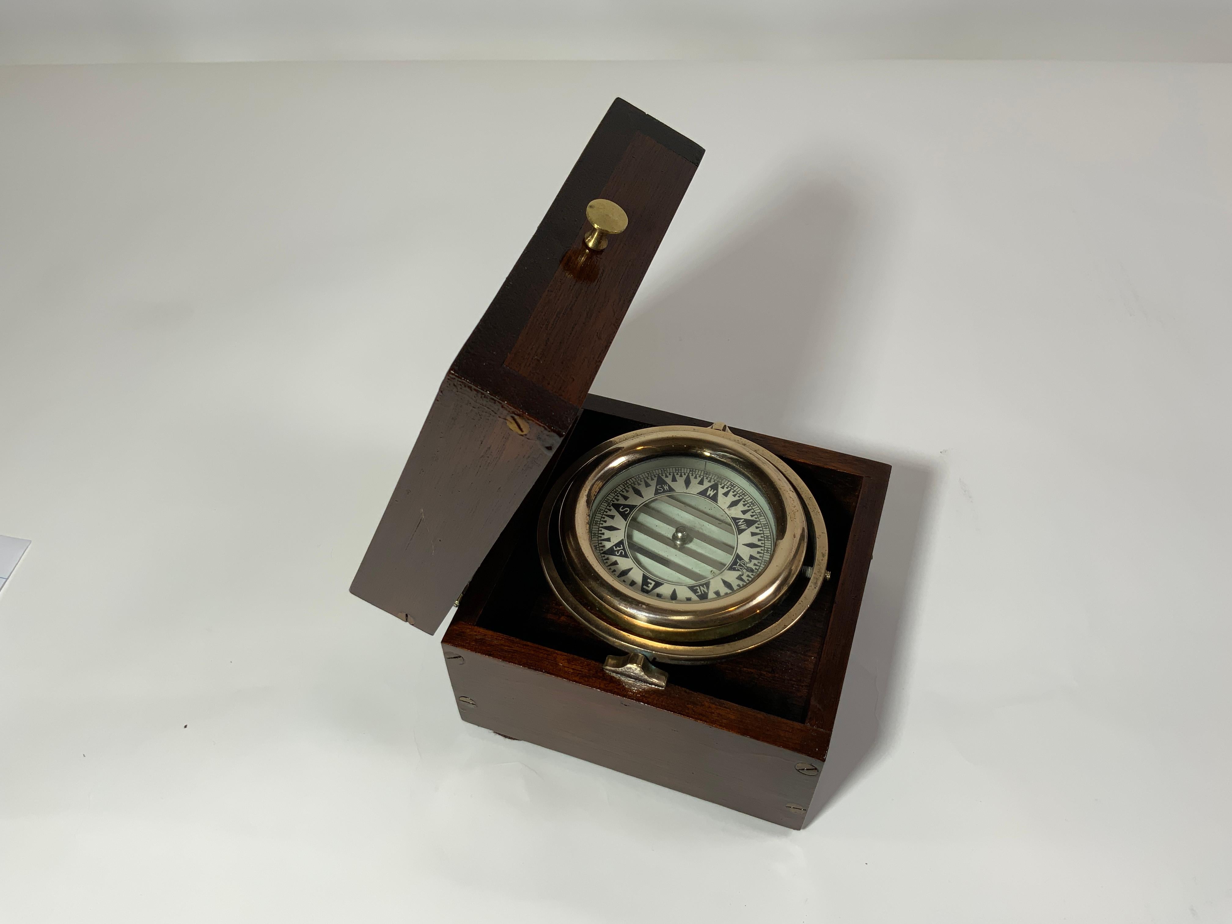 Highly polished solid brass yacht compass with gimbal. Fitted to a hinge top mahogany box with brass knob. Very fine piece. Compass card is marked with the monogram of Wilcox Crittenden of Middletown, Connecticut. Circa 1930. 

Overall dimensions: