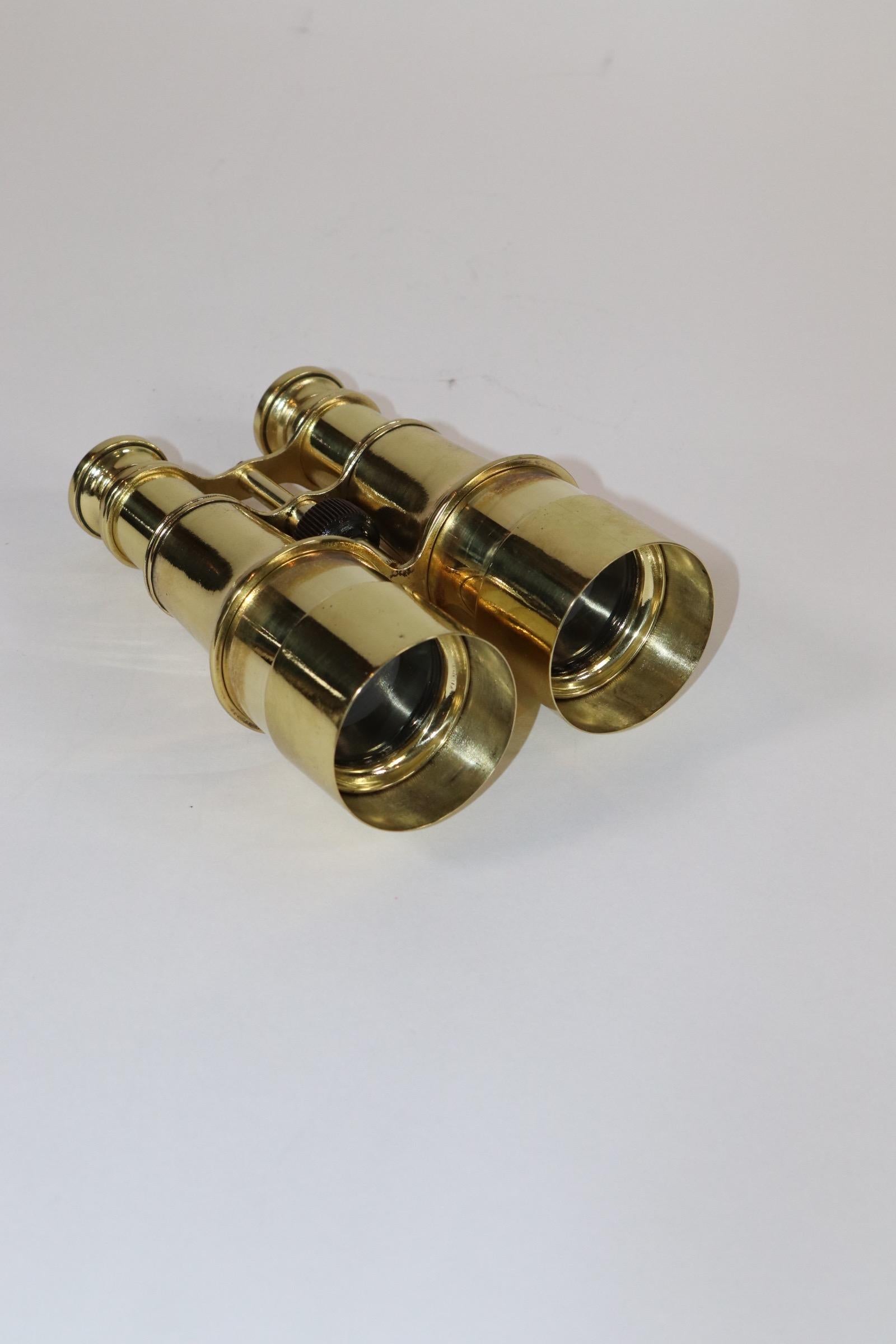 Pair of early 20th century French made yachting and field binoculars. Meticulously polished and lacquered. Center geared focal knob.