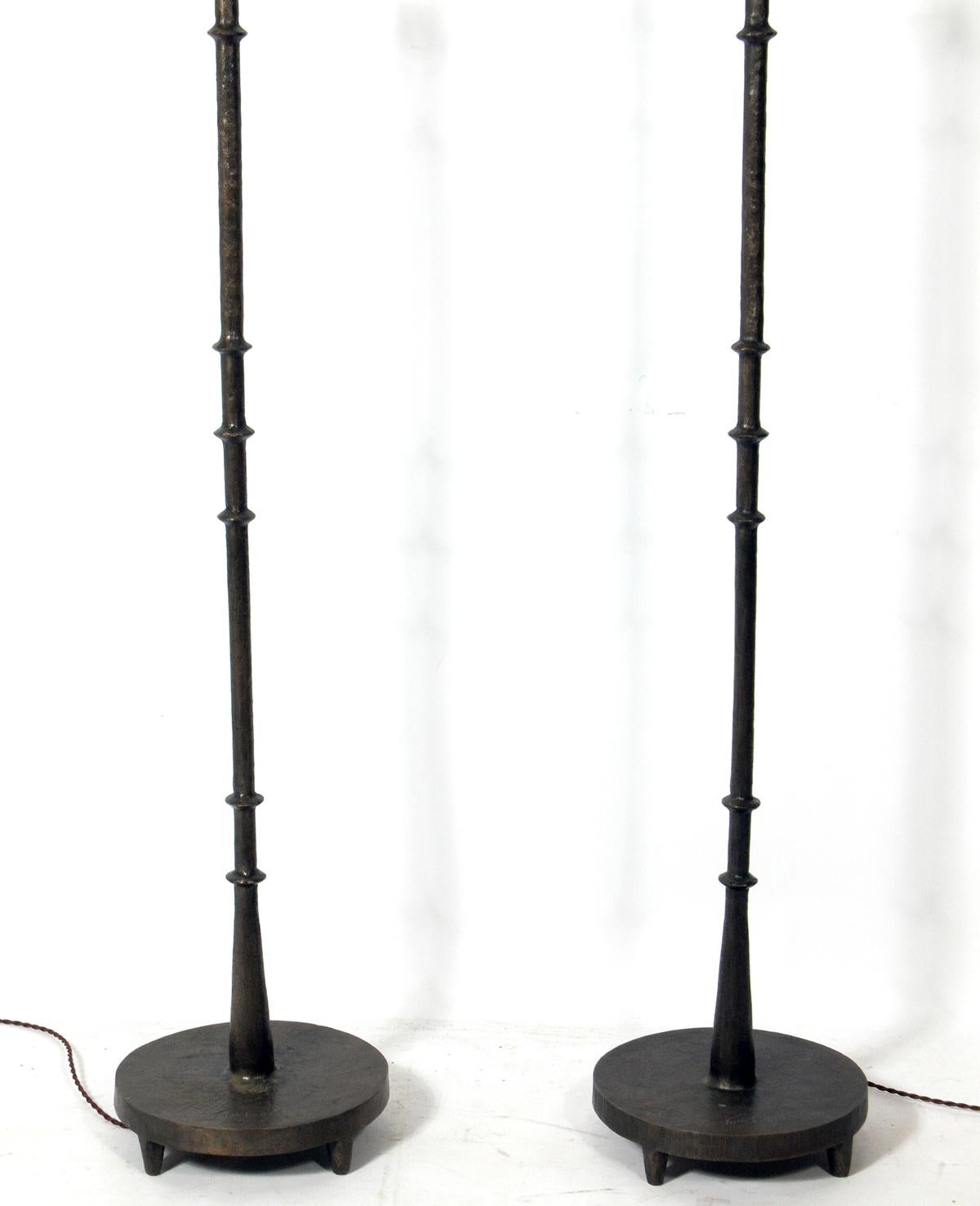 Solid bronze floor lamps by Tom Corbin, American, circa 2000s. They retain their warm original patina. Signed and dated at the bases. Corbin's work was clearly influenced by Diego Giacometti. The lamps have been rewired with cloth cords and the