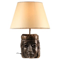 Solid bronze lamp base decorated with a crowned head