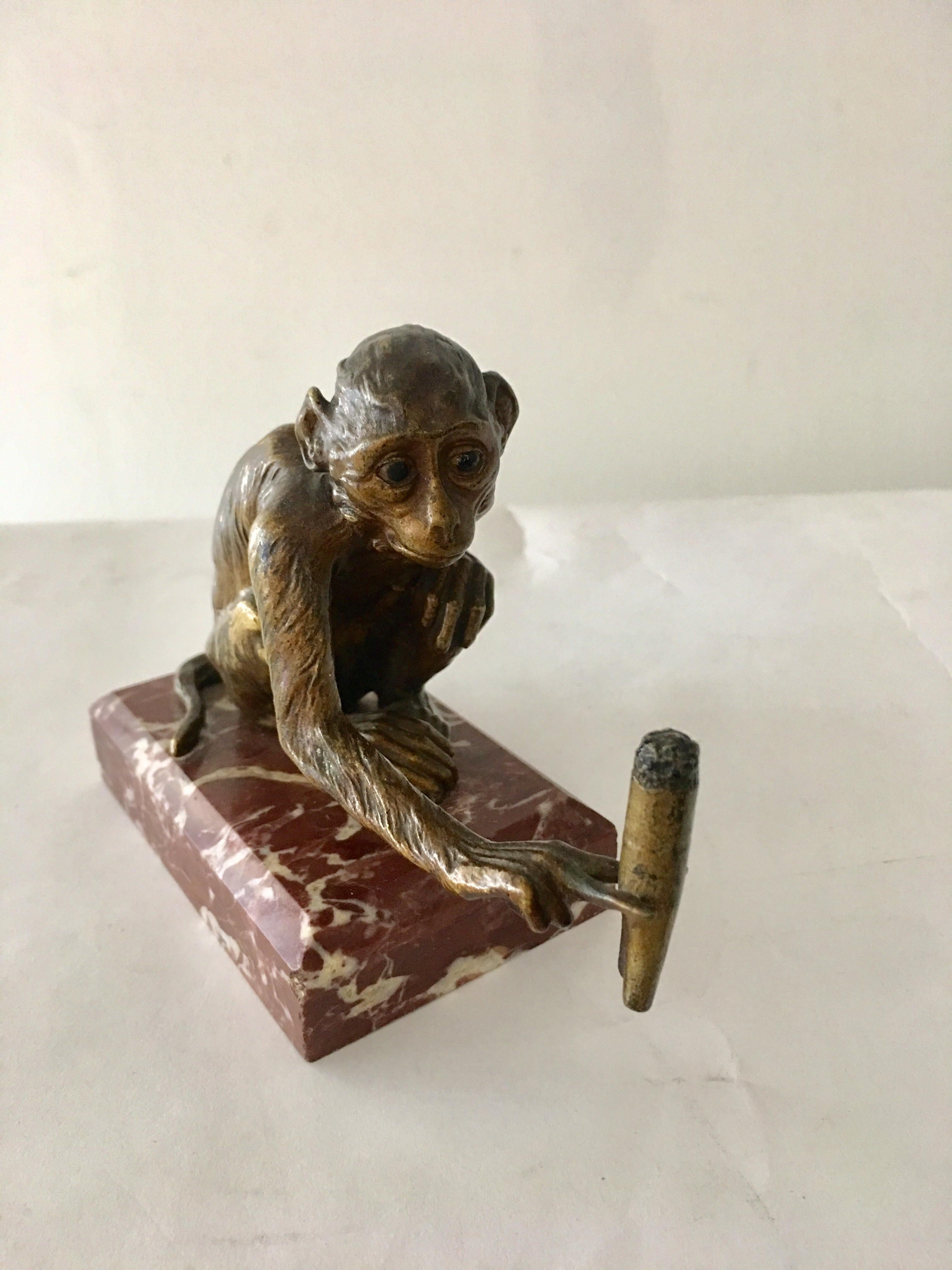 Very rare and unique sculpture. Monkey holding a cigar, solid bronze on marble base.