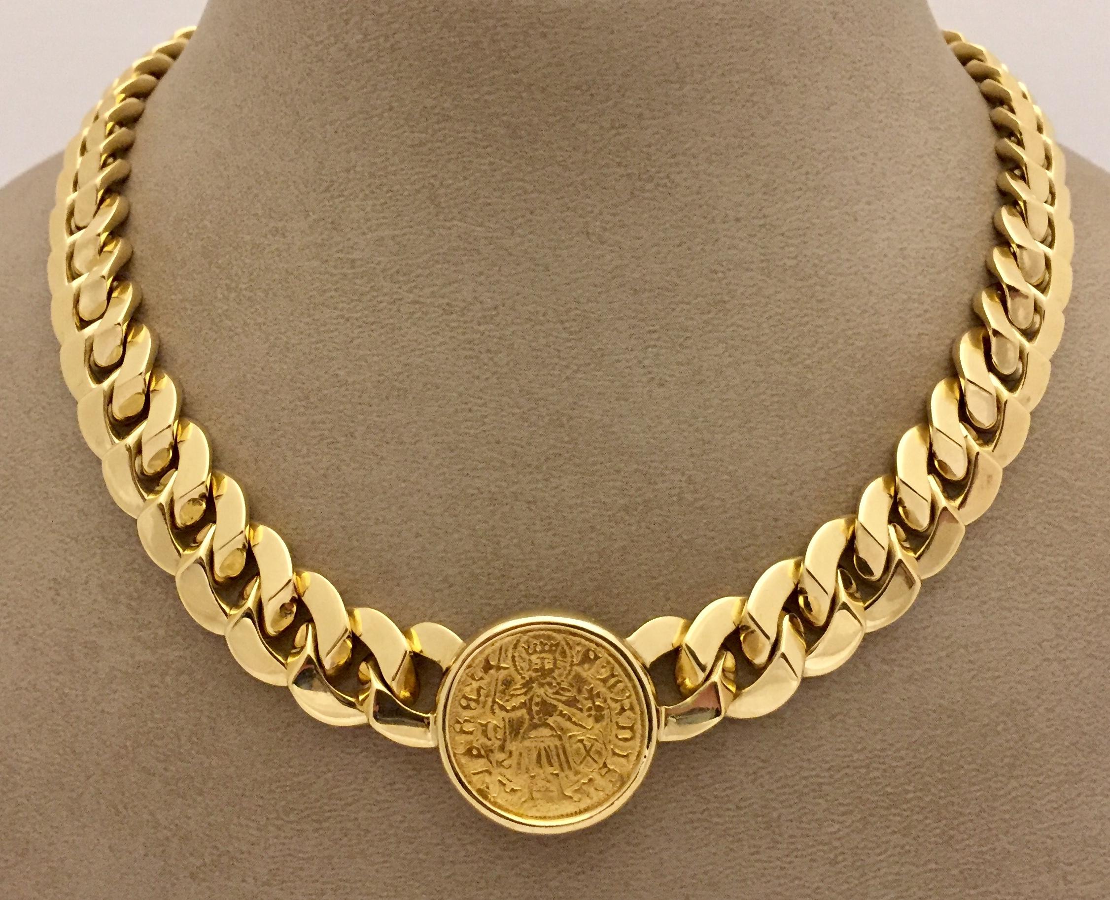 A massive coin necklace by BVLGARI. The 39 cm long 18k yellow gold graduated solid curb link chain suspending an ancient Roman gold coin mounted in a gold frame. A stunning example of the legendary Bulgari coin collection. Classic and bold, 145.75