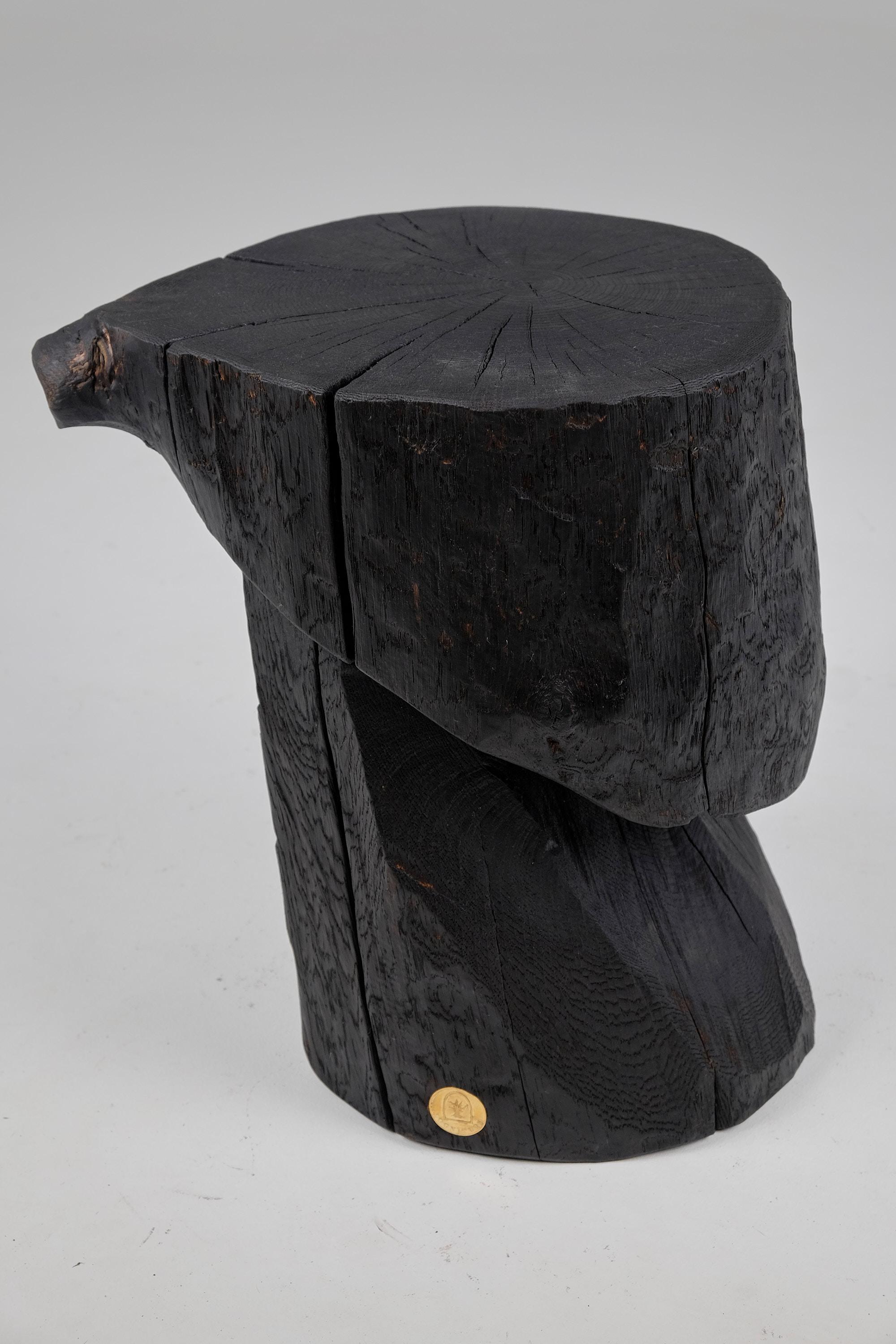 Chainsaw carved side table/pedestal. Carved from a single piece of burnt oak wood and protected with the highest quality oils, ensuring durability for generations. Such unique handmade design will highlight your interior and bring comfort to your