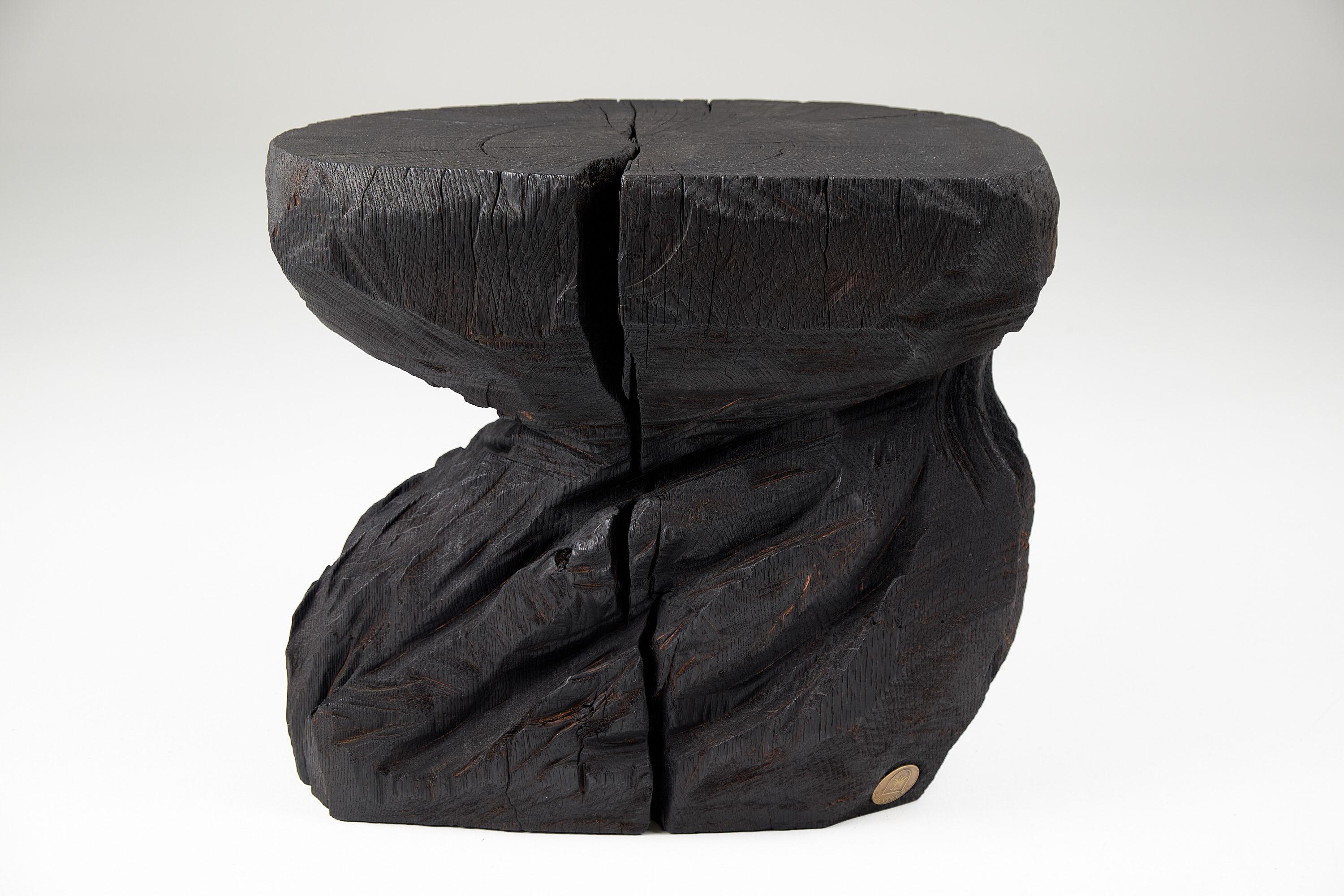 Chainsaw carved stool/side table. Carved from a single piece of burnt oak wood and protected with the highest quality oils, ensuring durability for generations. Such unique handmade design will highlight your interior and bring comfort to your home,