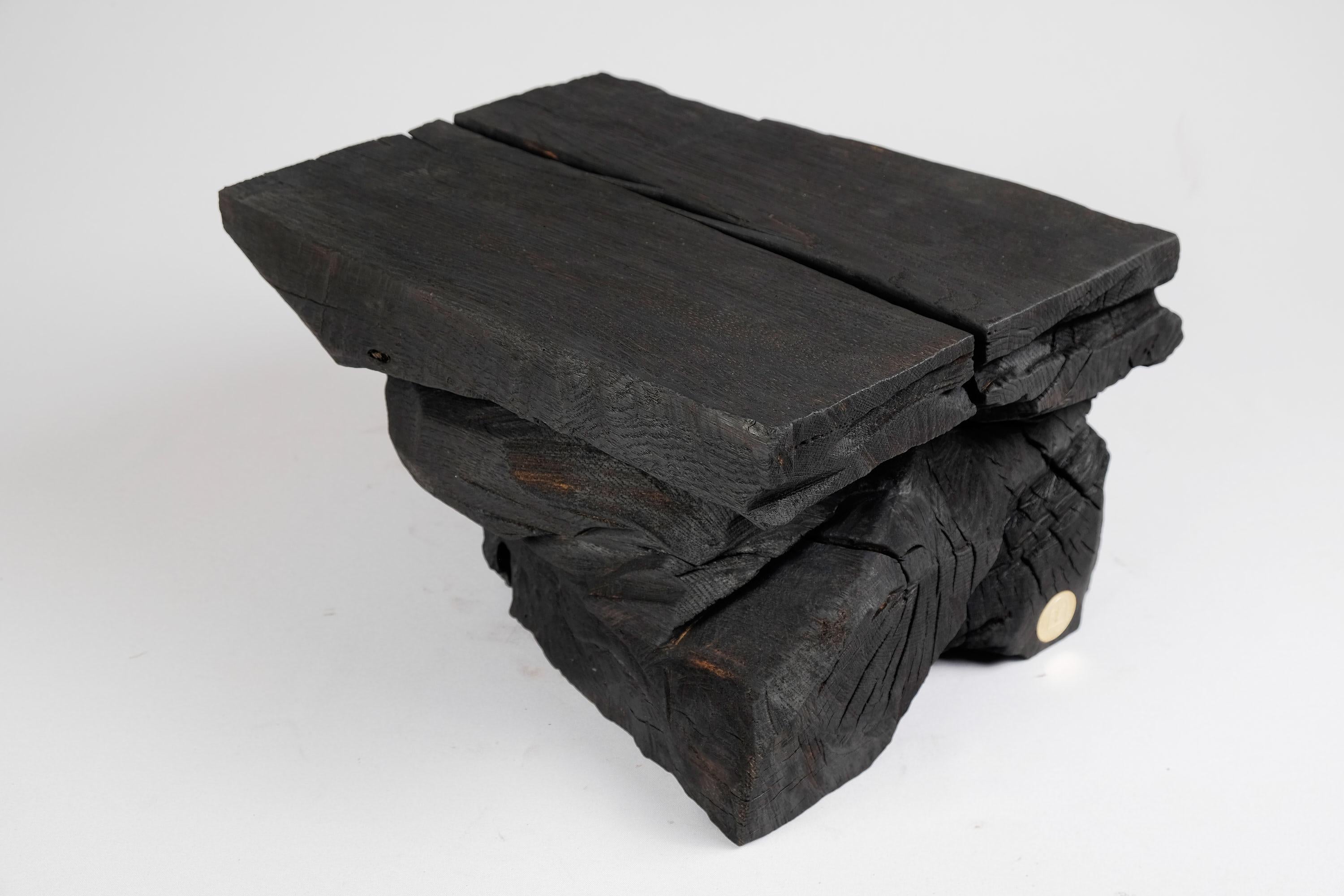 Chainsaw carved stool/side table. Carved from a single piece of burnt oak wood and protected with the highest quality oils, ensuring durability for generations. Such unique handmade design will highlight your interior and bring comfort to your home,
