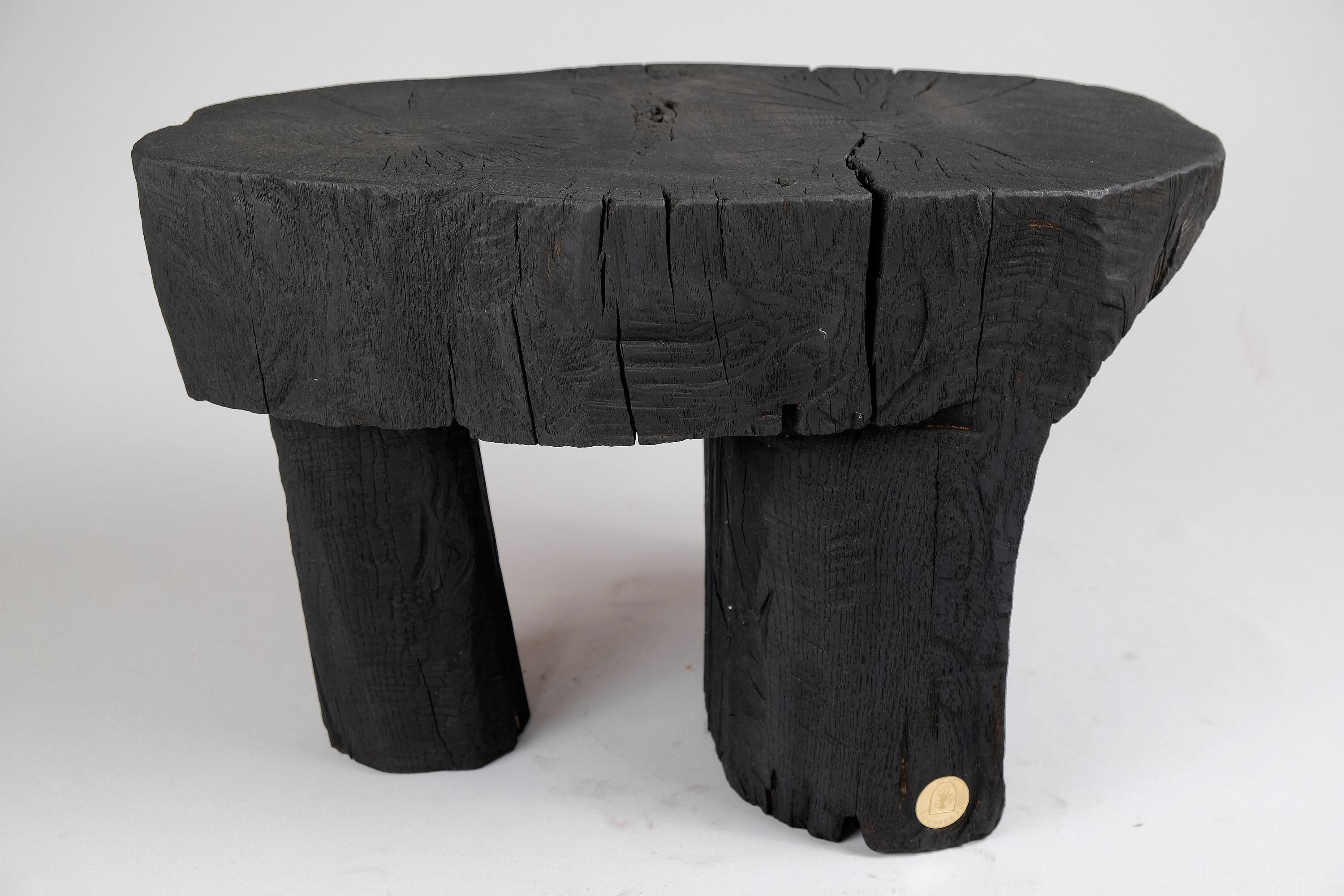 Unique chainsaw carved wooden contemporary rustic side table/stool. Carved from a single piece of wood and protected with the highest quality oils, ensuring durability for generations. Such unique handmade design will highlight your interior and