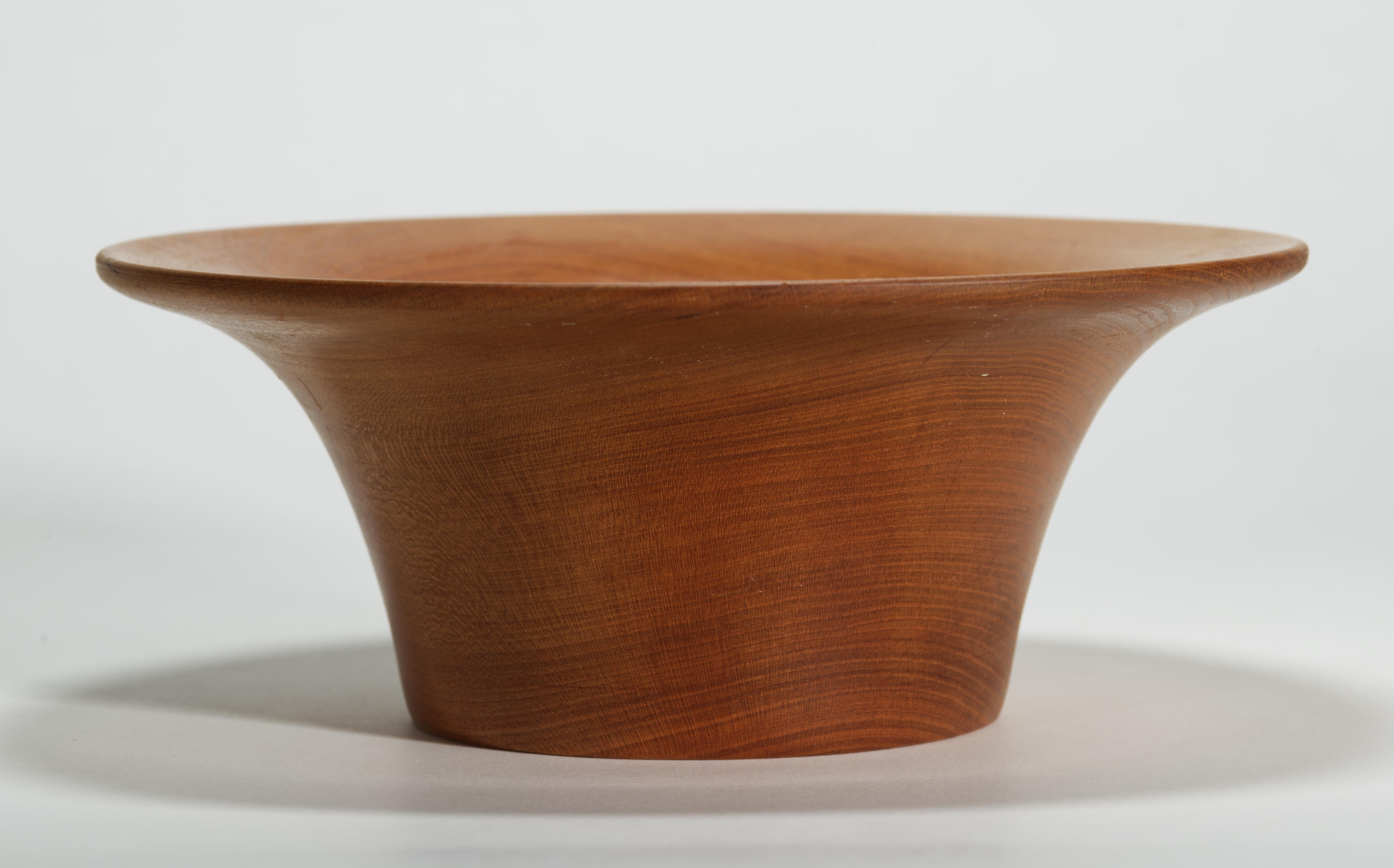 The hand carved round wood bowl features Modernist shape and graphic wood grain patterns with the natural tonal range. Minimal shape of the bowl showcases the organic charm and decorative qualities of the rare Korina wood.

The bowl is signed and