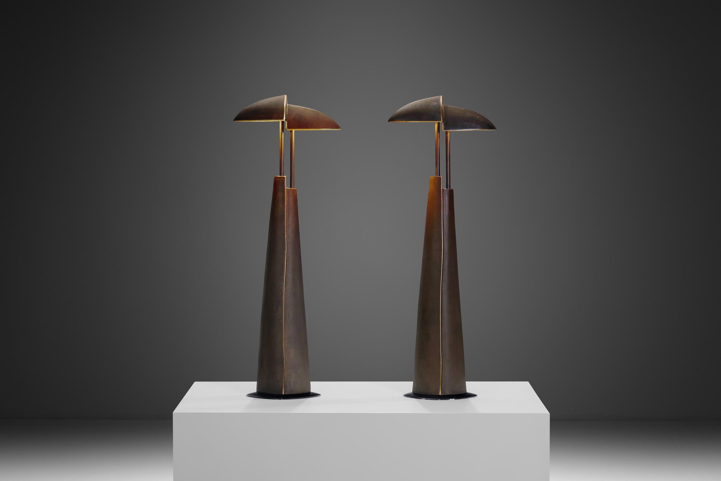 This pair of Annette van Gessel and Von Ullrich Mies designed heavy cast table lamps is a striking piece of late 20th century design.  Utilitarian by design, the medium is forged with a simplicity of efficiency in mind, with just a glance towards