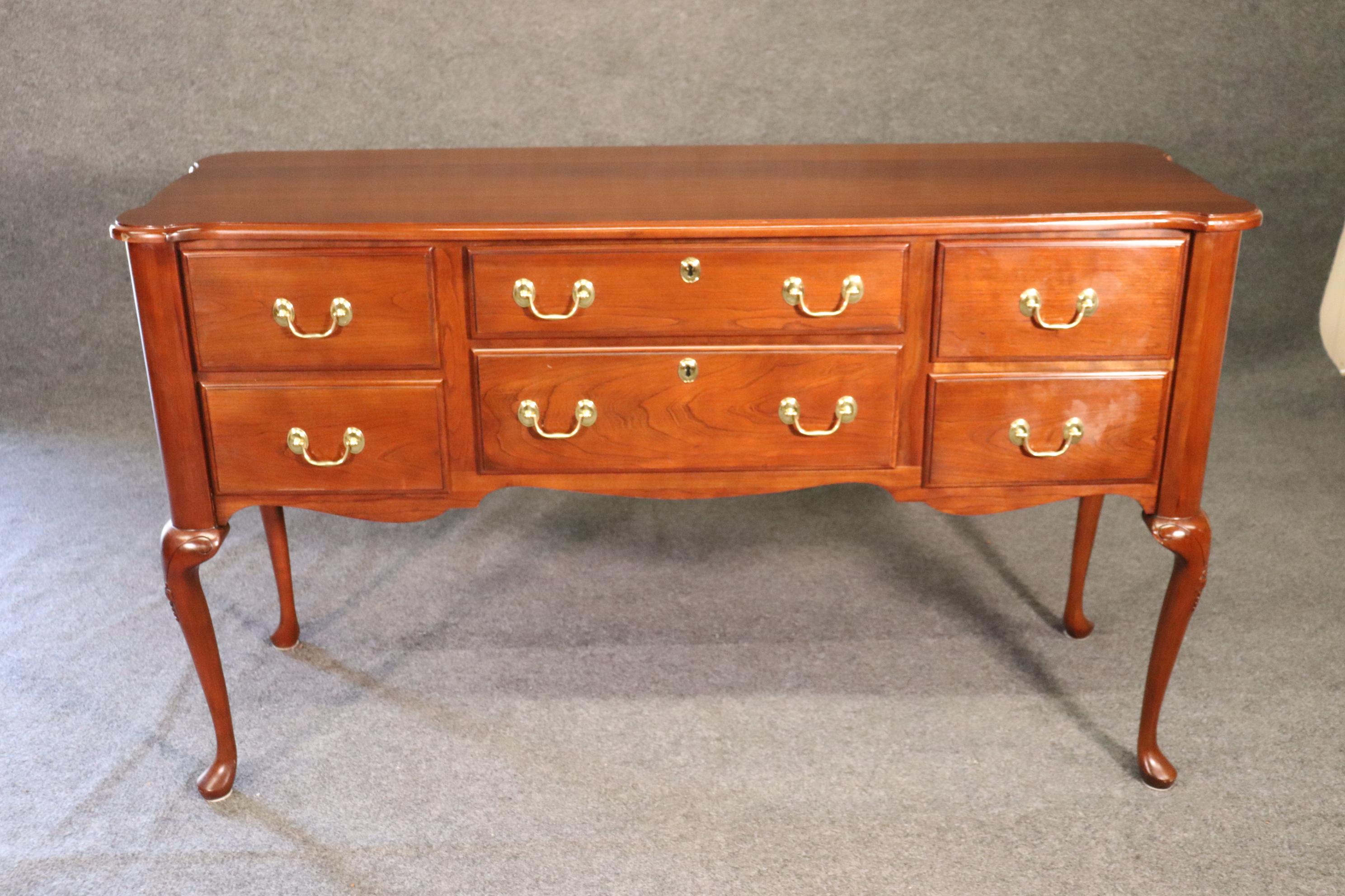 This is a solid cherry Harden sideboard in good used condition from the 1980s. The piece measures 60 wide x 21 deep x 35 tall.