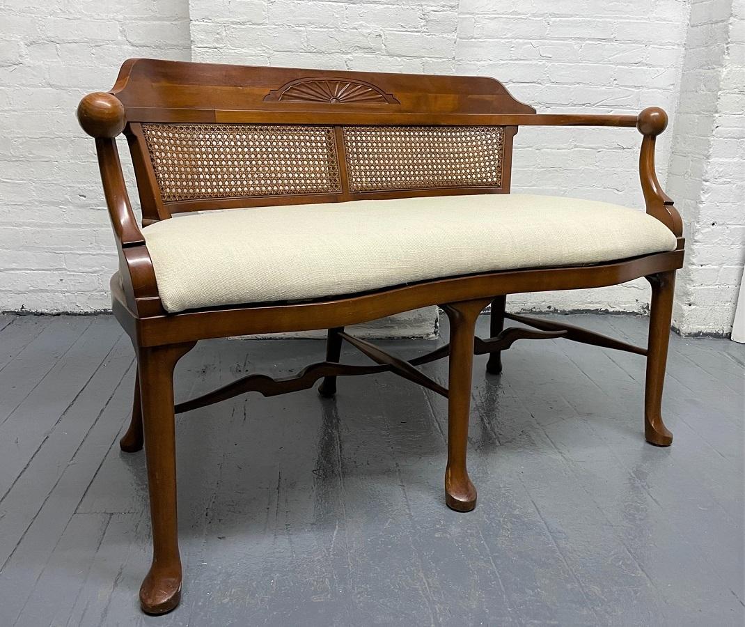 Two, Solid cherrywood Country style benches. The benches have caned backs, fabric seats and is solid Cherrywood. The arms are turned and has a solid ball to the tips of the arms.
Priced individually.  