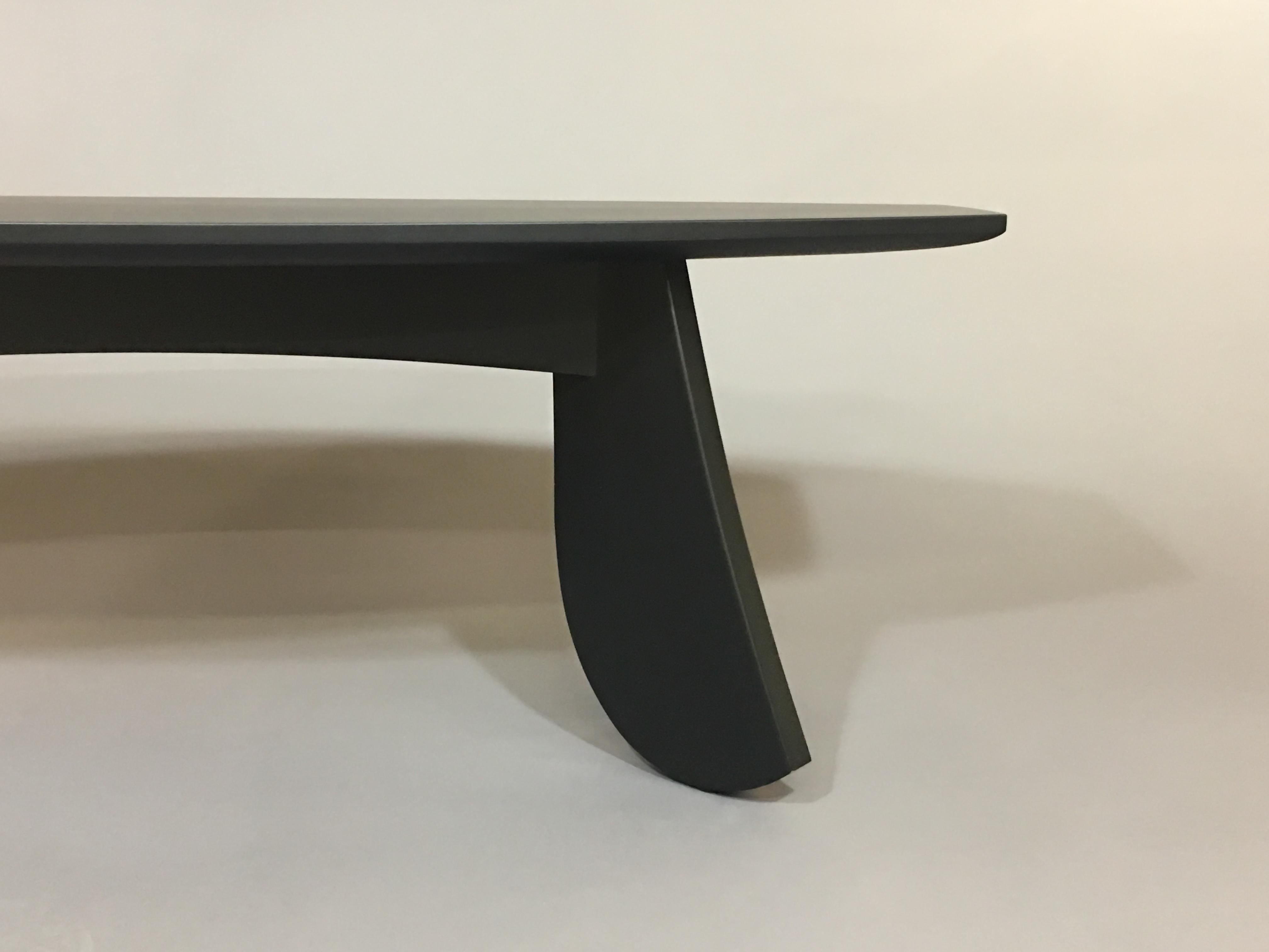 Elongated designed table/bench. Made from solid cherry with a pure pigmented black primer, finished with a clear coat of conversion varnish. Legs constructed using mortise and tenons. The top is hand sculpted on the underside and along the edges.