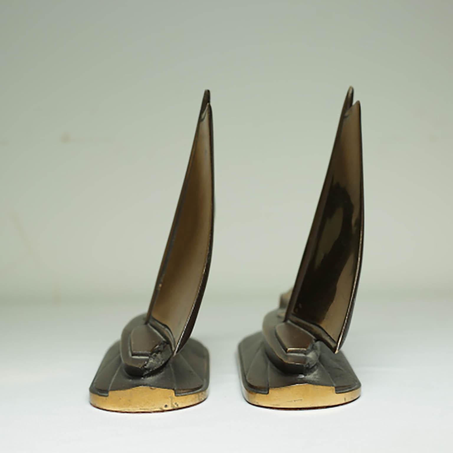 ABOUT

This is an original pair of bronze and copper bookends. The main body is bronze with copper finish on the sails and around the base. Both pieces retain the original felt on the bottom. The bookends have retained their original copper and