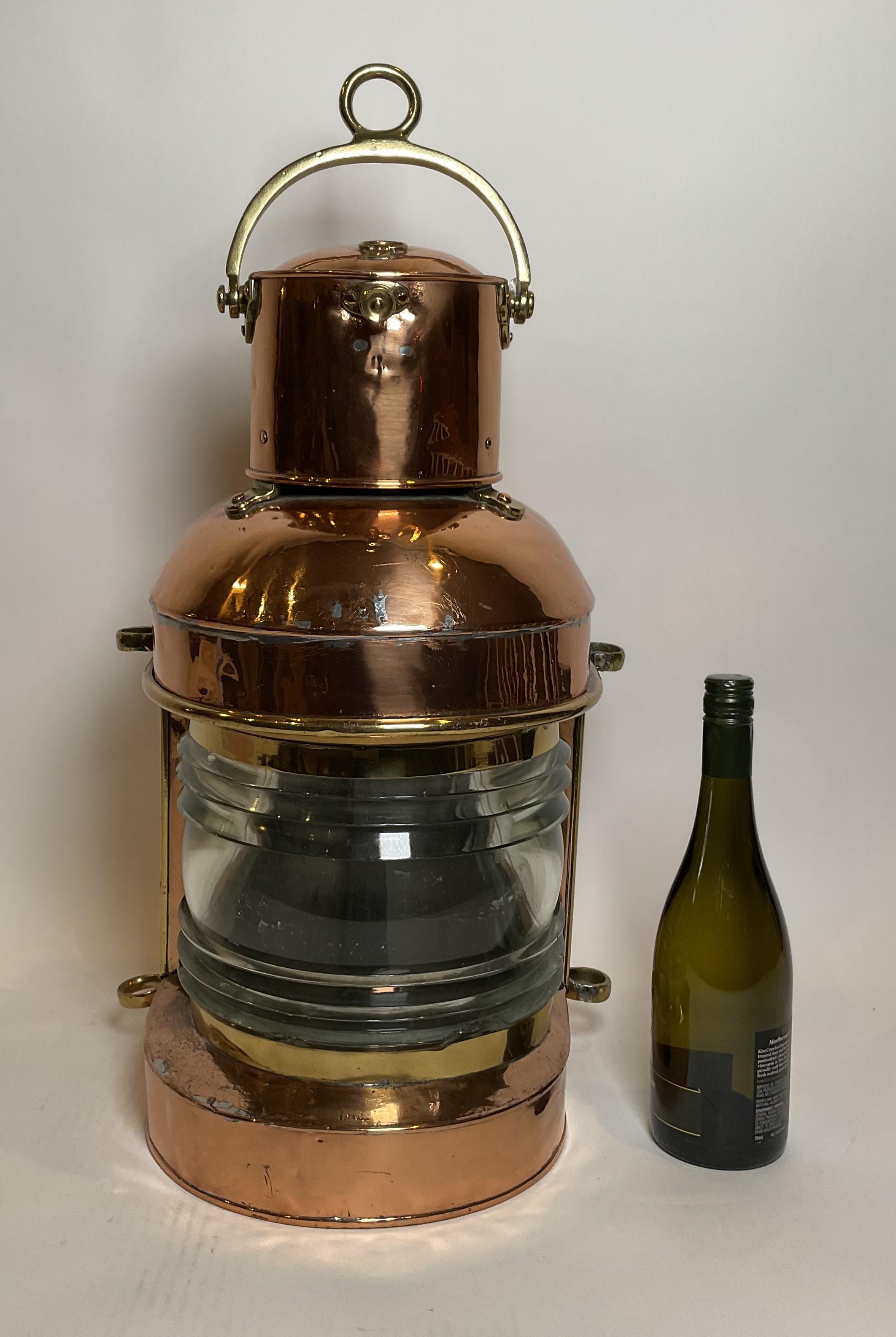 Beautiful polished copper ships masthead lantern with glass fresnel lens, original burner, hinged door, etc. Brass fittings include mounting rings, carry handles, chimney mounts, and lens trim. Awesome design. Circa 1920.

Weight: 17 lbs.
Overall