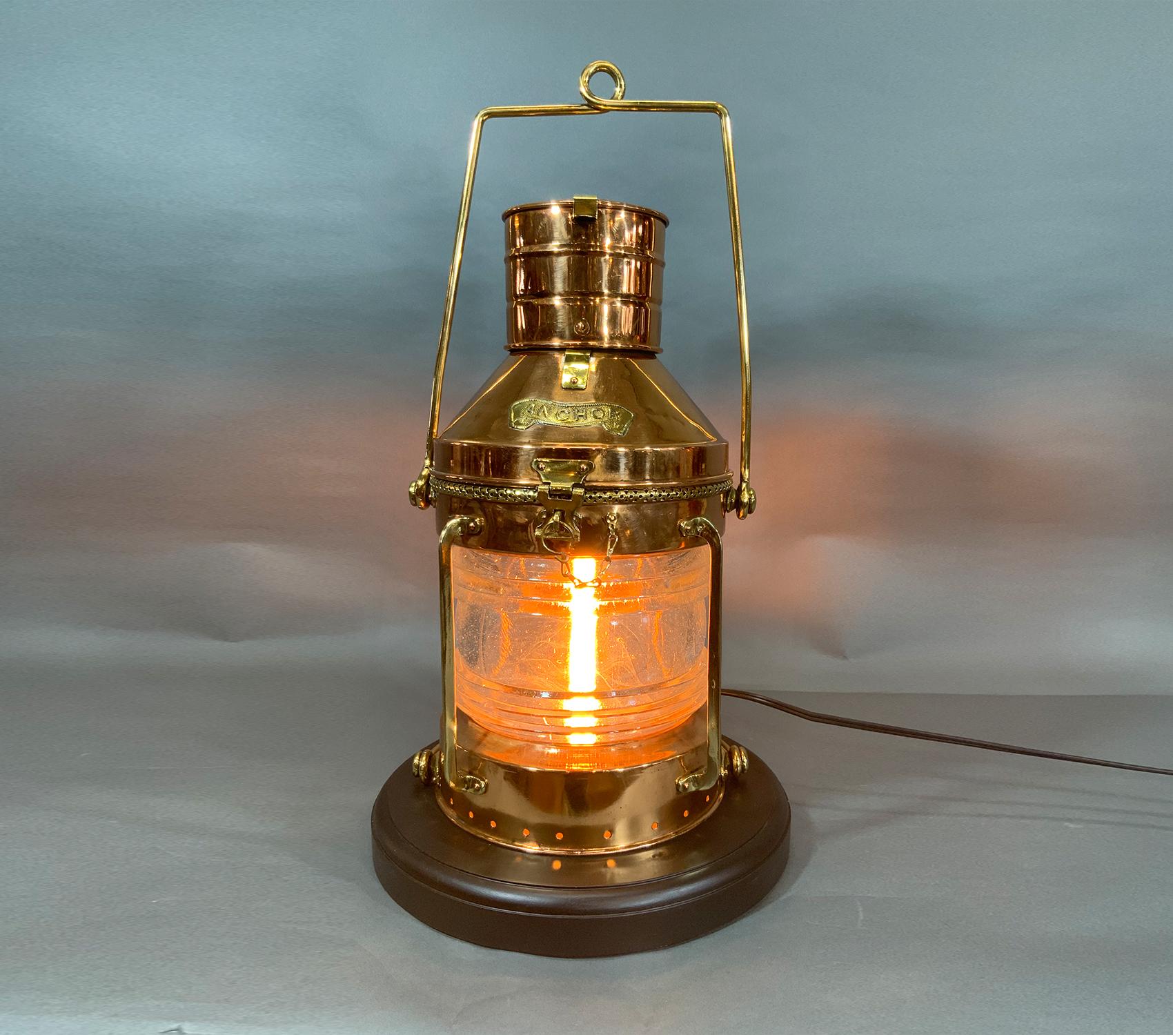 Ships anchor lantern of solid copper with brass handles, bars, hasp, hinge, etc. Mounted to a thick wood base. Wired for home use. Condition good, couple of dents.

Weight: 19 LBS
Overall Dimensions: 21