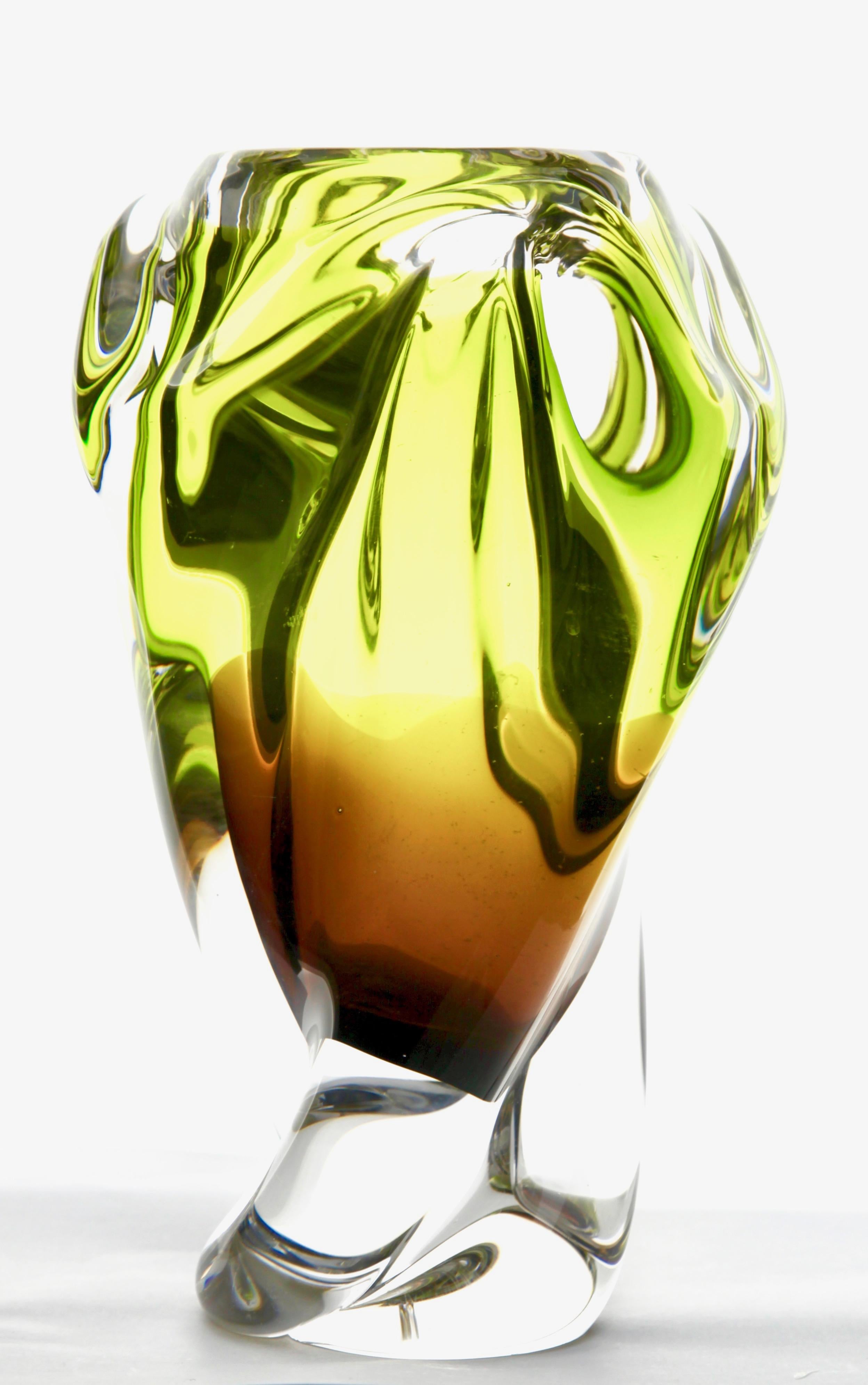 Solid crystal biomorphic vase with waves of bright green and sommerso.

This heavy biomorphic crystal glass vase has been made in Bohemia (modern Czechia) inspired by the designs of Jaroslav Baranek. In the mid-1960s they were mainly produced in