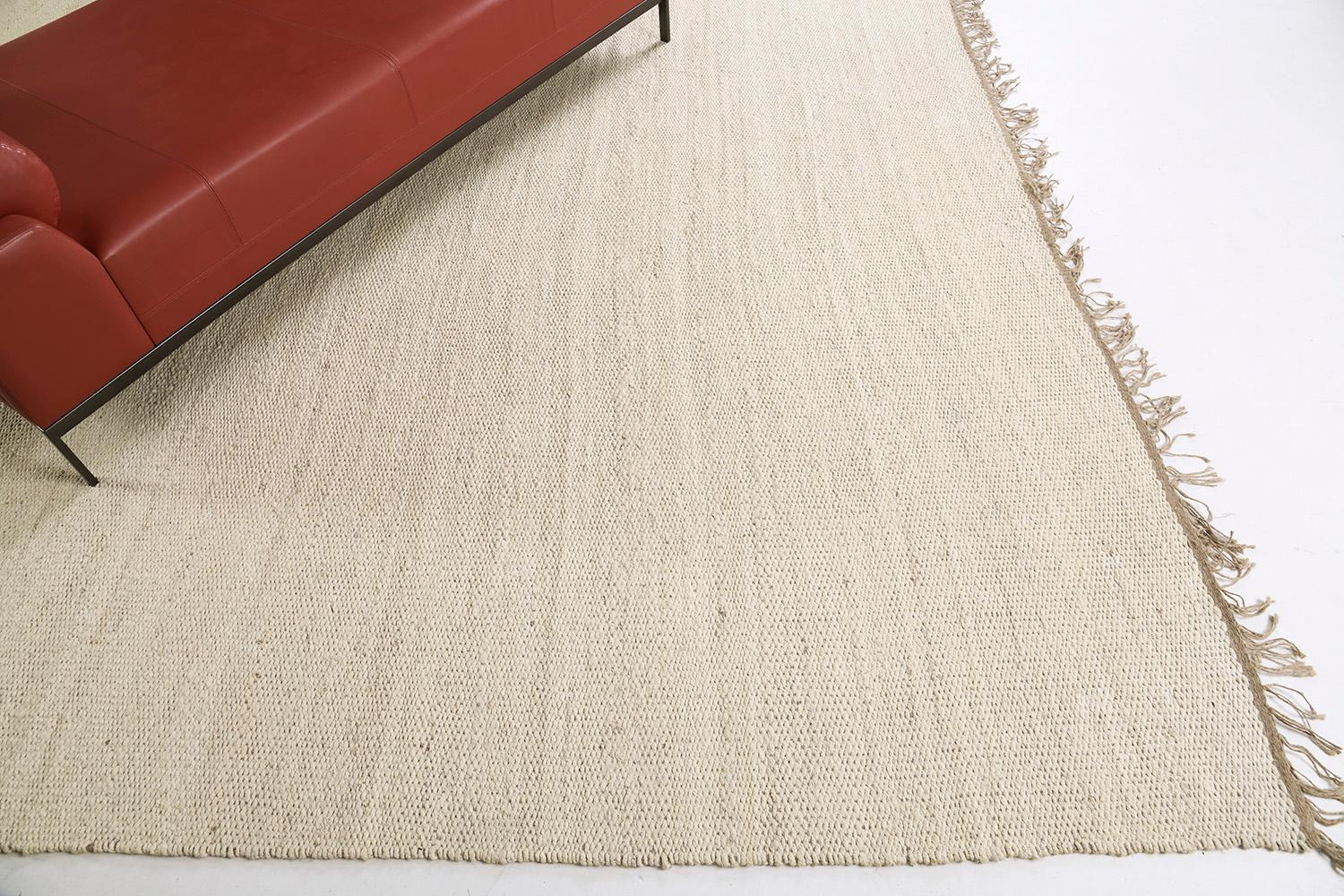 A solid design flatweave features horizontal strokes of gold-tone hemp. Embedded with beautiful tassels that match the simplicity yet a sophisticated kind of masterpiece. This decor will add harmonies to your modern interior and lift the mood of