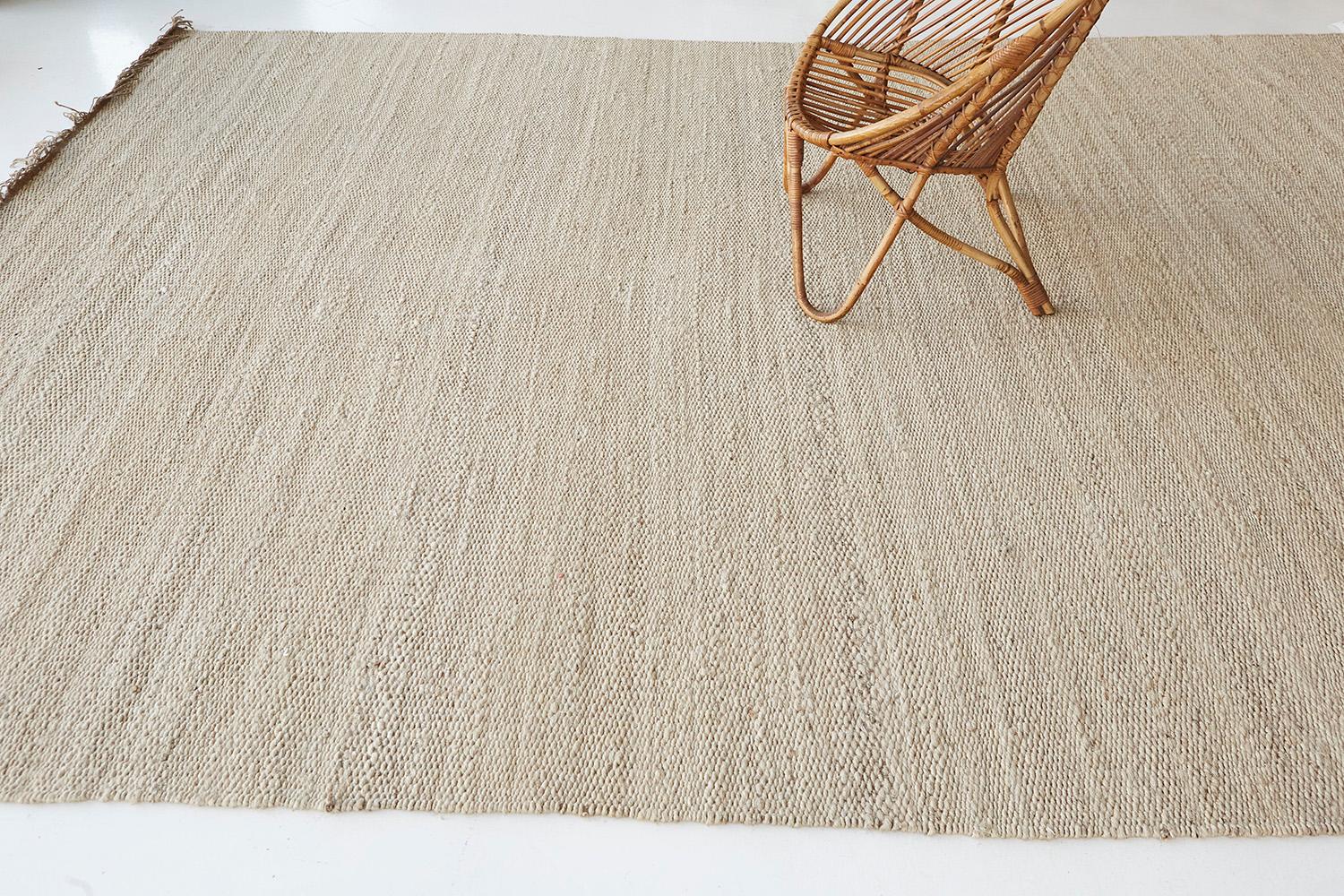 A solid design flatweave features a horizontal stroke of the neutral tone of hemp. Embedded with beautiful tassels that match the simplicity yet a sophisticated kind of masterpiece. This decor will add harmonies to your modern interior and lift the