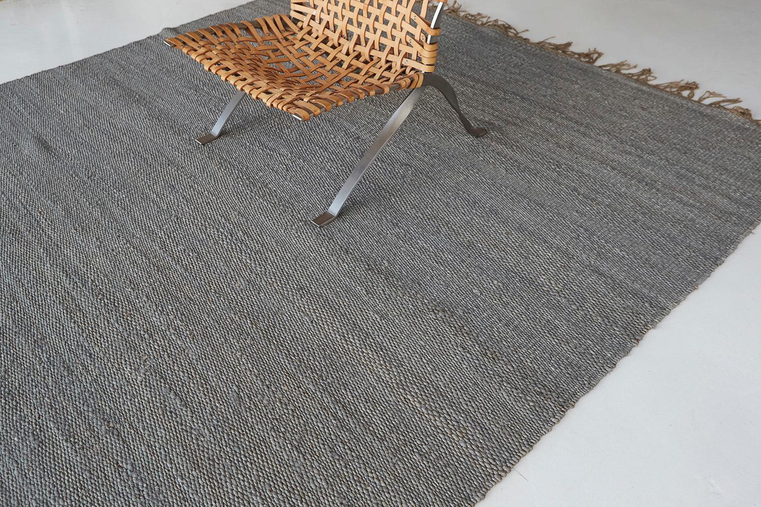 A solid design flatweave features a horizontal stroke of the neutral tone of hemp. Embedded with beautiful tassels that match the simplicity yet a sophisticated kind of masterpiece. This decor will add harmonies to your modern interior and lift the