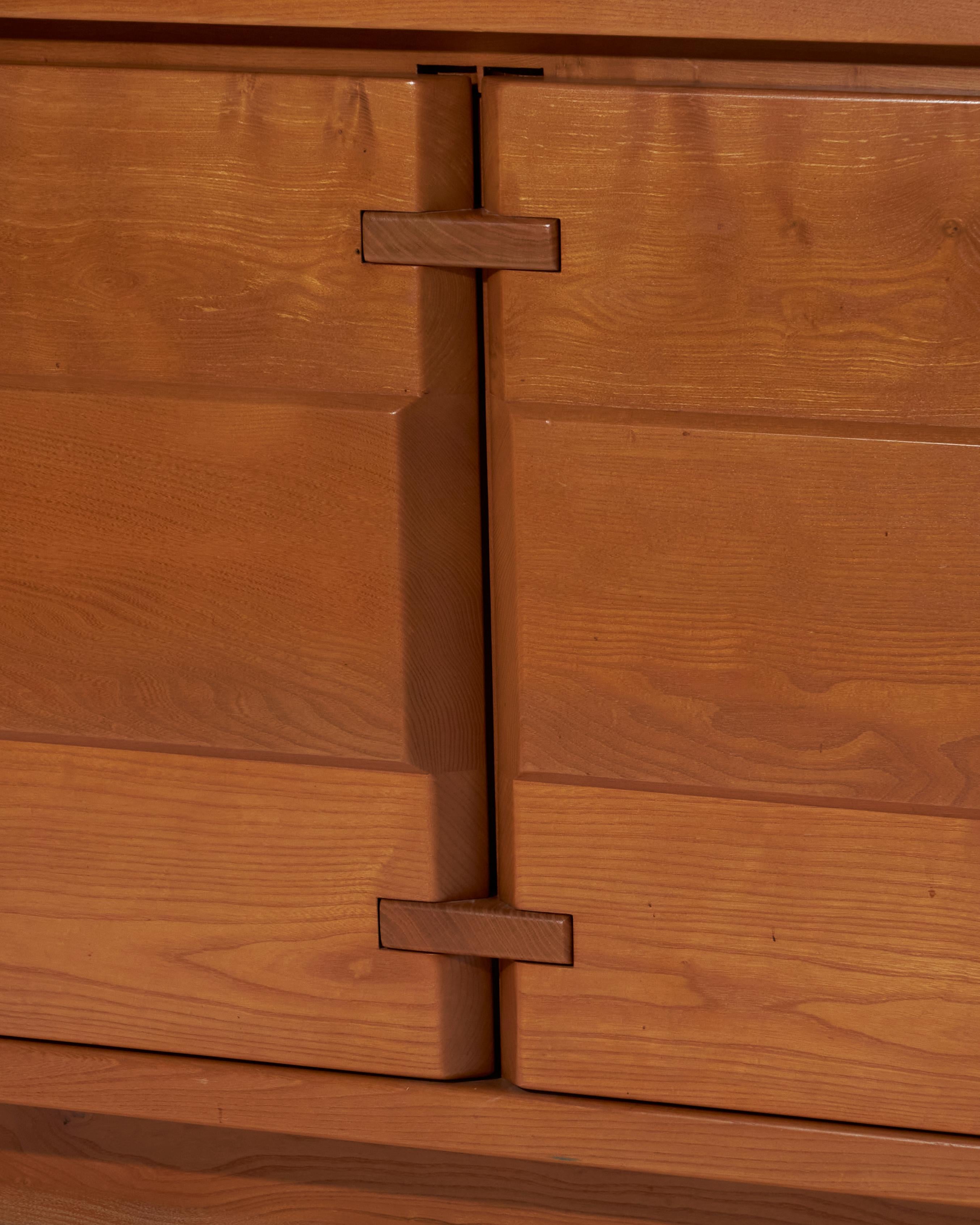 Solid elm sideboard, echoing the aesthetic of Maison Regain or Charlotte Perriand’s creations. Its clean, understated, and timeless design highlights the natural beauty of the wood, enhanced by an elegant grain and functional structure.

It features