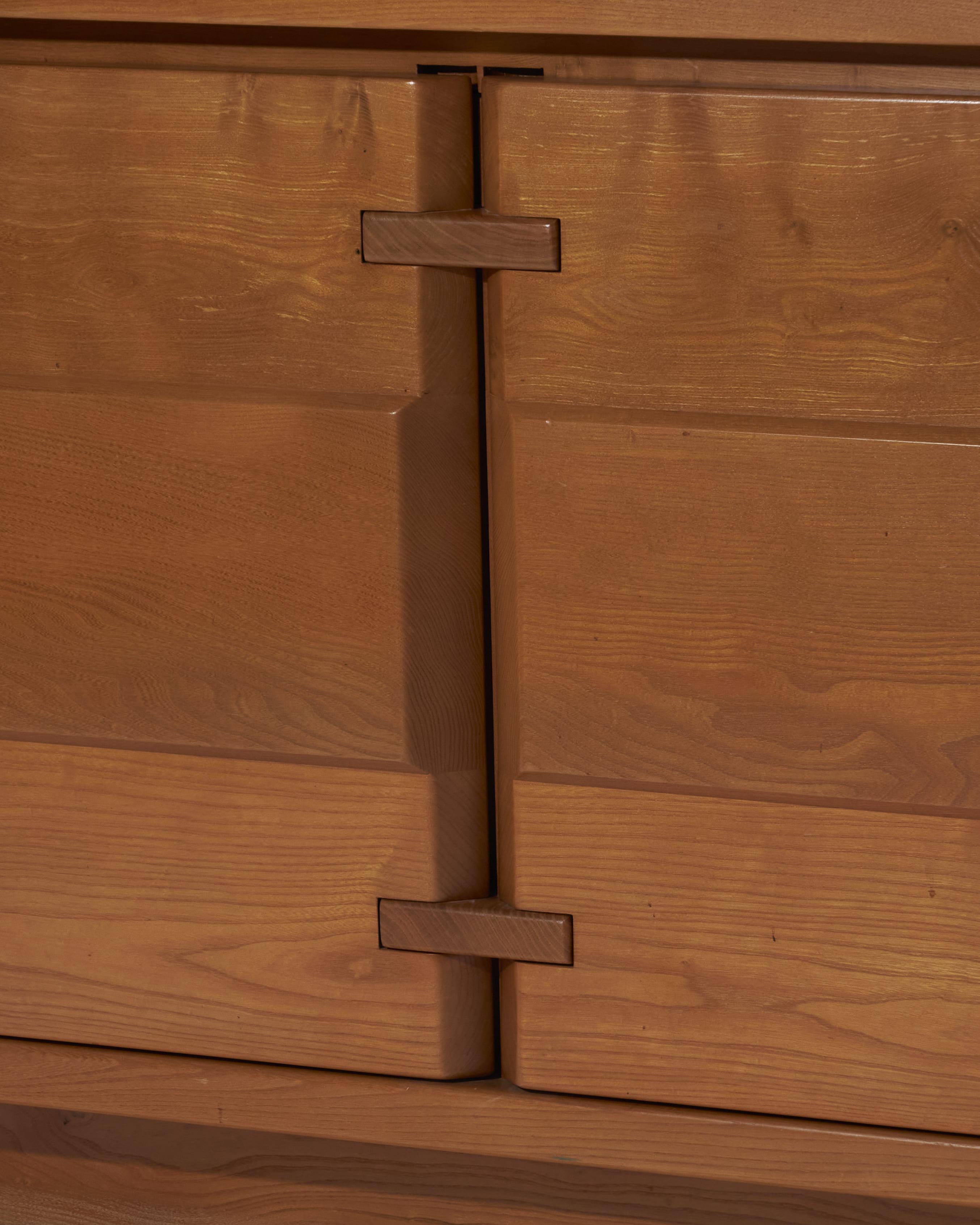 Solid elm sideboard, echoing the aesthetic of Maison Regain or Charlotte Perriand’s creations. Its clean, understated, and timeless design highlights the natural beauty of the wood, enhanced by an elegant grain and functional structure.

It features