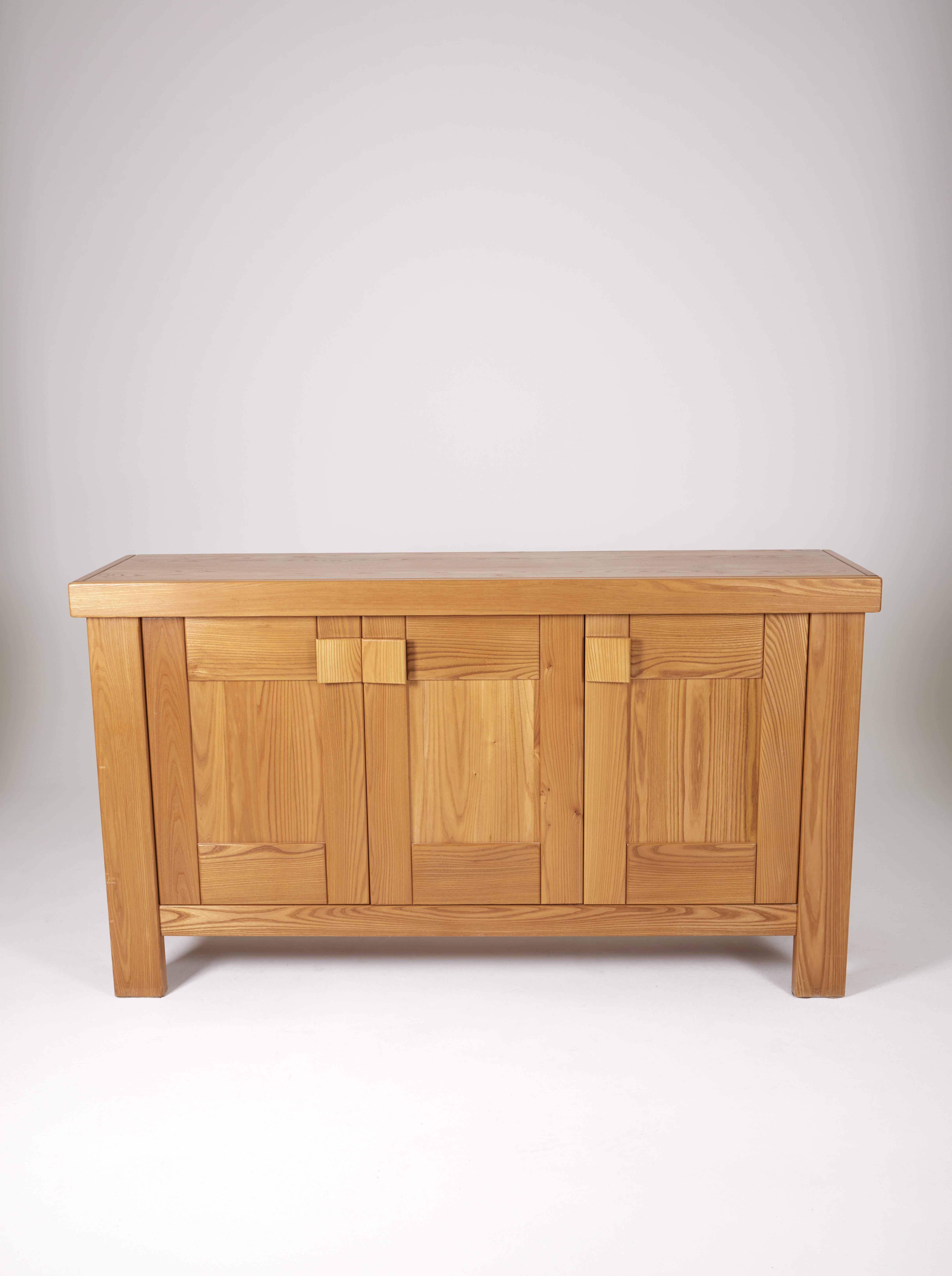 Solid elm sideboard edited by Maison Regain in the 70s. Equipped with two storage spaces, with shelf on the left side and drawer on the right side. Very good condition.