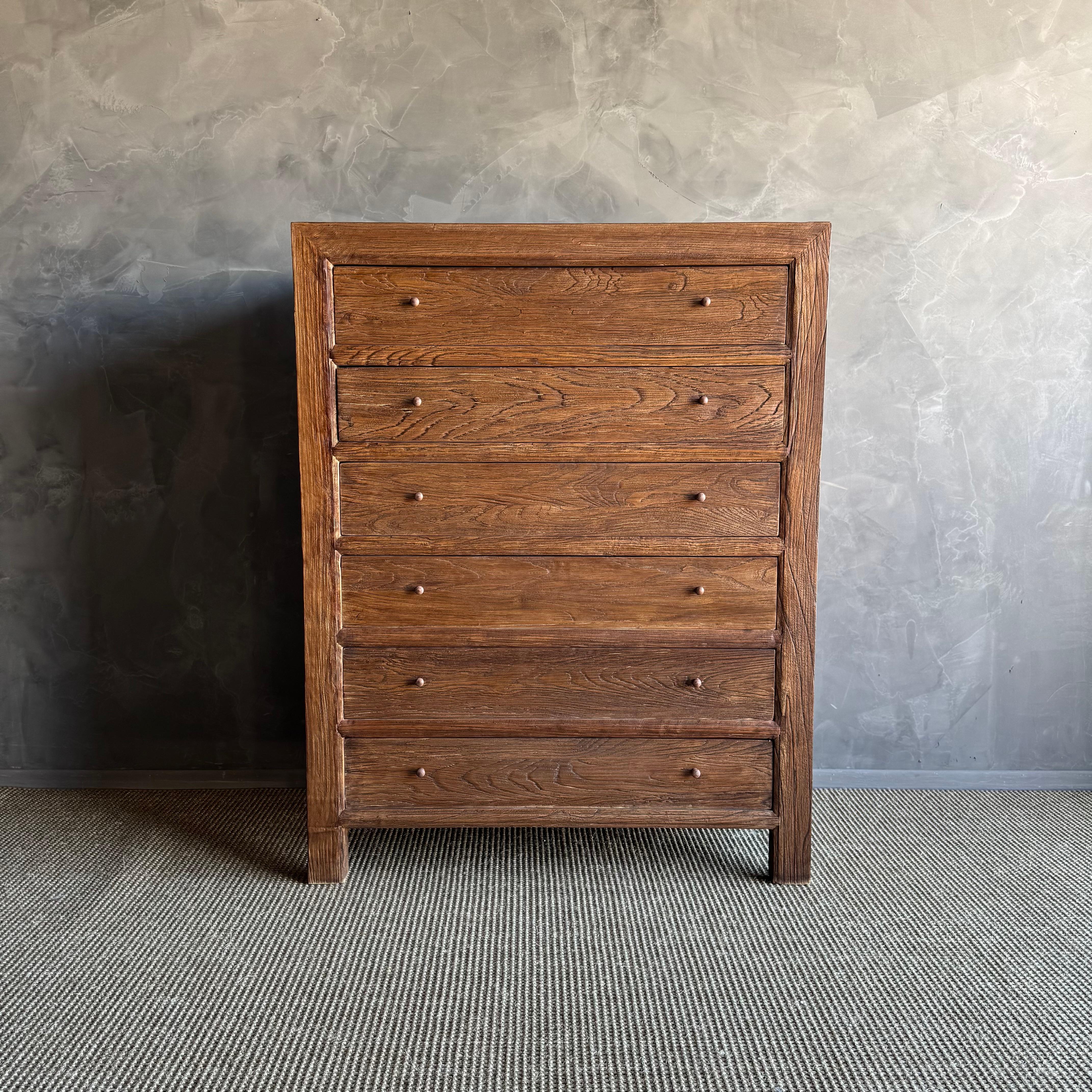 Introducing the Ollie solid elm wood dresser, expertly crafted from reclaimed elm wood and finished in a rich walnut stain. 
This exquisite dresser features six spacious drawers that provide ample storage for all your clothing and essentials. The