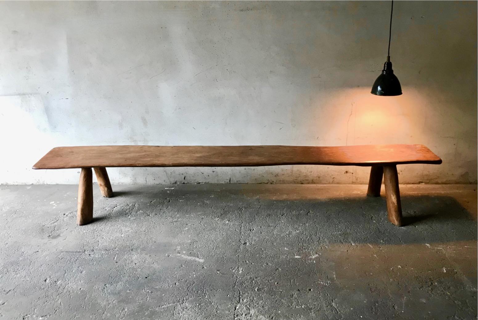 Beautiful solid brutalist Bench made of Elmwood attributed to Olavi Hanninen, for Miko Nupponen, Finland,1950’s. The bench is characterized by its raw concrete and stark, geometric forms combined with the contrast of the warm, natural qualities of