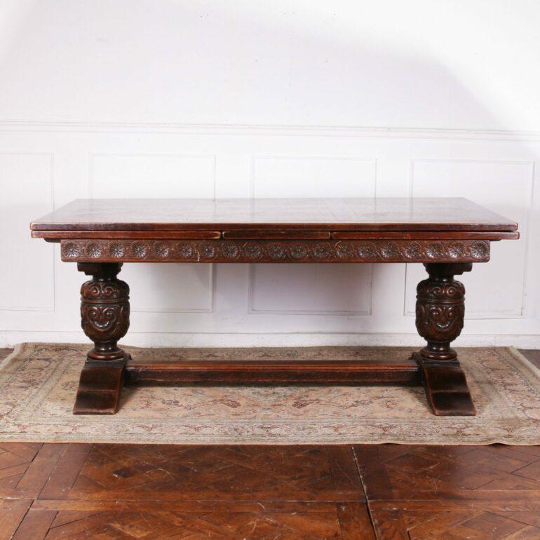 Solid French oak refectory draw leaf dining table. This piece is has a beautiful hand carved base. Sitting on top is a stunning solid ( not veneer ) top with a diamond pattern. The draw leaves extend out so you can seat twelve people.