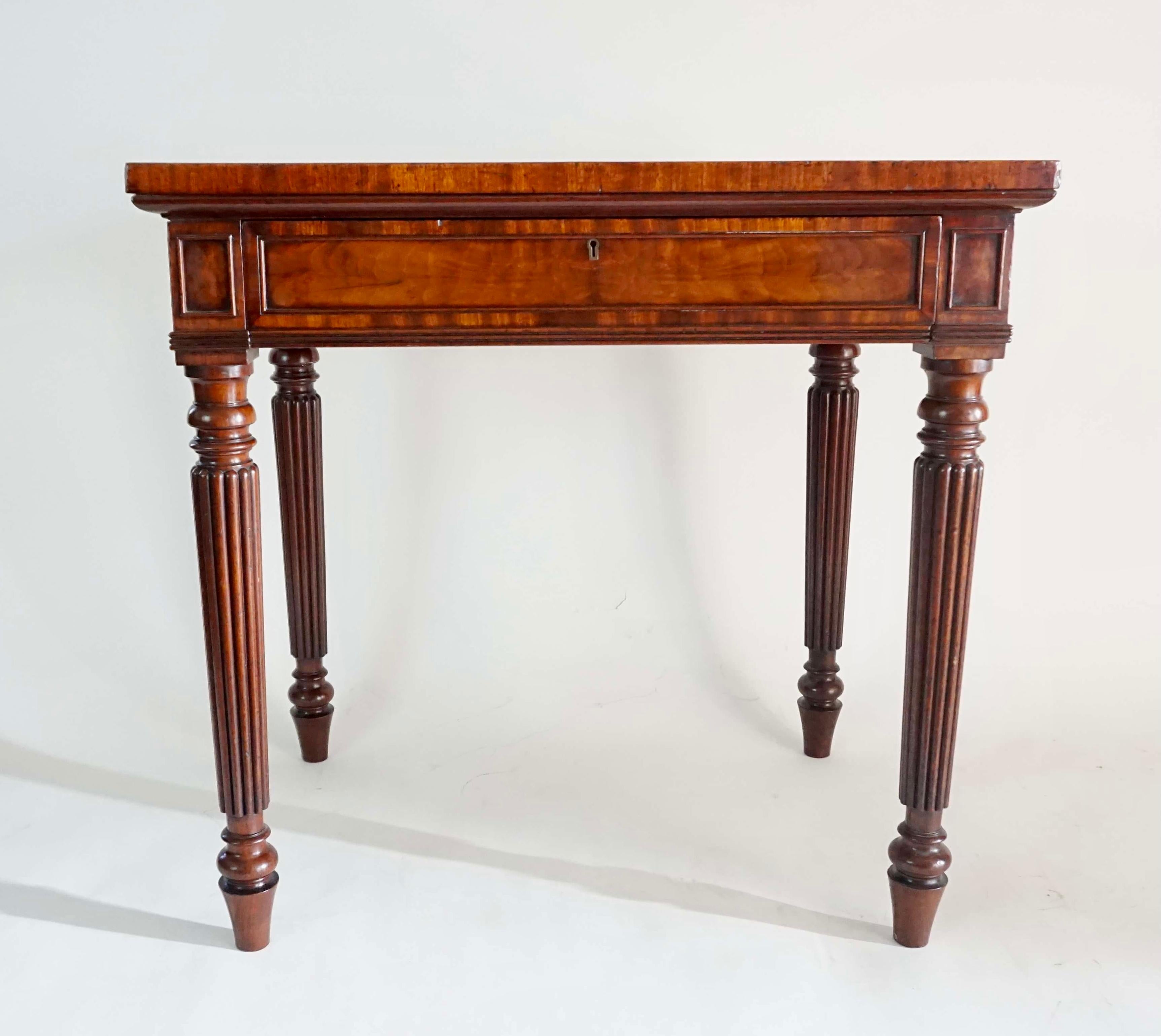 An extremely fine circa 1820 side or writing table by legendary English cabinetmaking firm of Gillows of Lancaster and London of rectangular form having an exquisitely grained solid 'crocodile' mahogany top on solid mahogany base having 'wainscot'