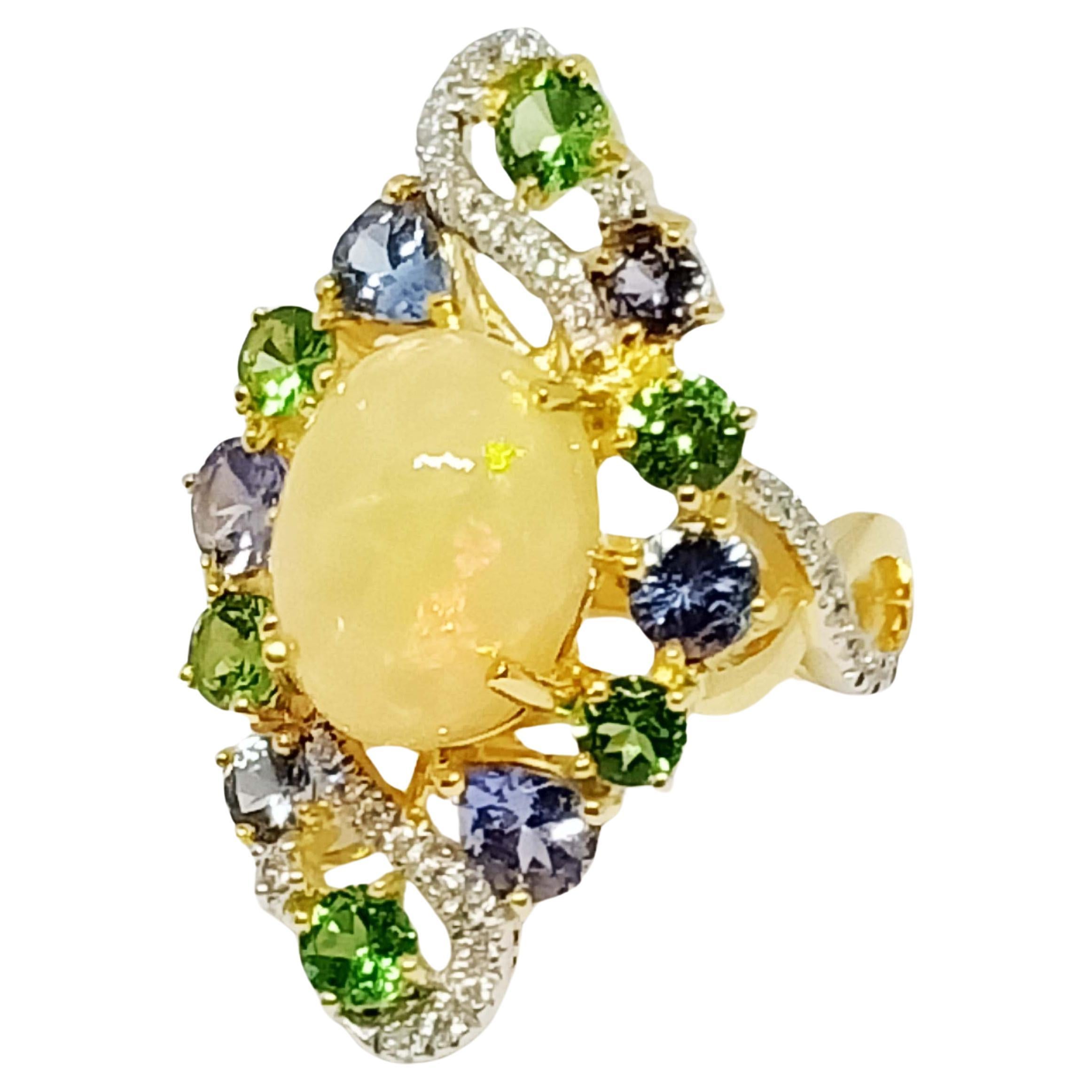 Opal  Oval 12.2x9.2  4.43 cts
Tsavorite round  3.5 , 3.0 mm.   1.18 cts
Tanzanite round 3.0 , 4.0 mm   0.79 cts
Tanzanite Pear 5x4 mm. 0.50 cts.
Diamond round 1.0  , 1.25 mm. 38 pcs. 0.22 cts
Solid Gold 14 K

