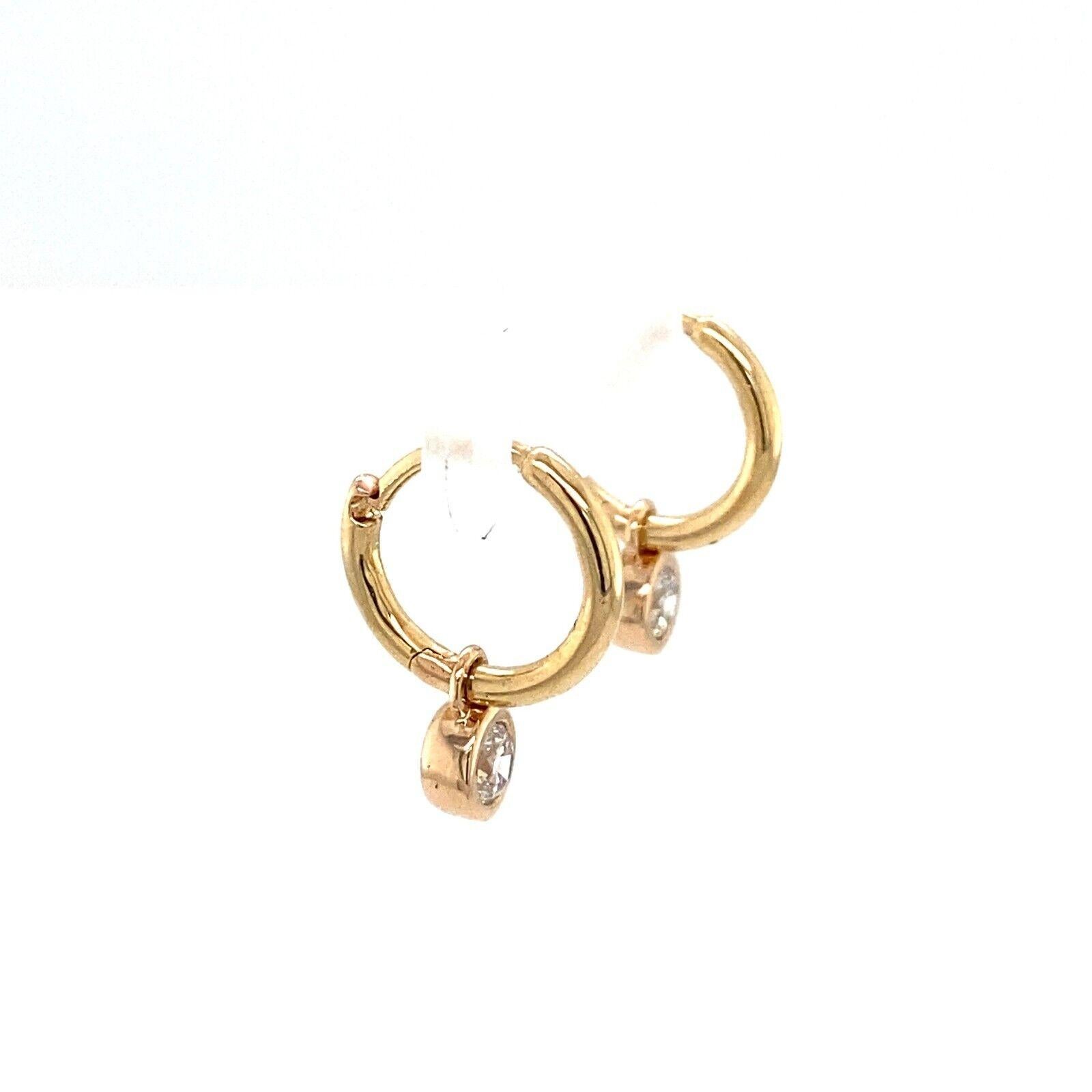These stunning earrings are the perfect pair to add to your collection. These 14ct Yellow Gold hoop earrings have a total of 0.25ct Round Brilliant Cut Diamonds is set in a bezel setting and attached to the hoop plain earring.

Additional