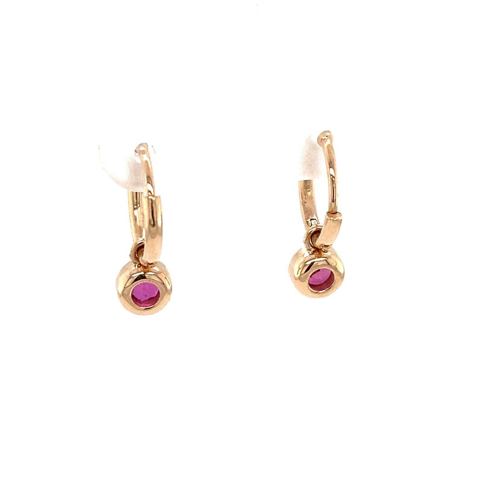 These stunning earrings are the perfect pair to add to your collection. These 14ct Yellow Gold hoop earrings have a total of 0.60ct Round Brilliant Cut natural Rubies is set in a bezel setting and attached to the hoop plain earring.

Additional