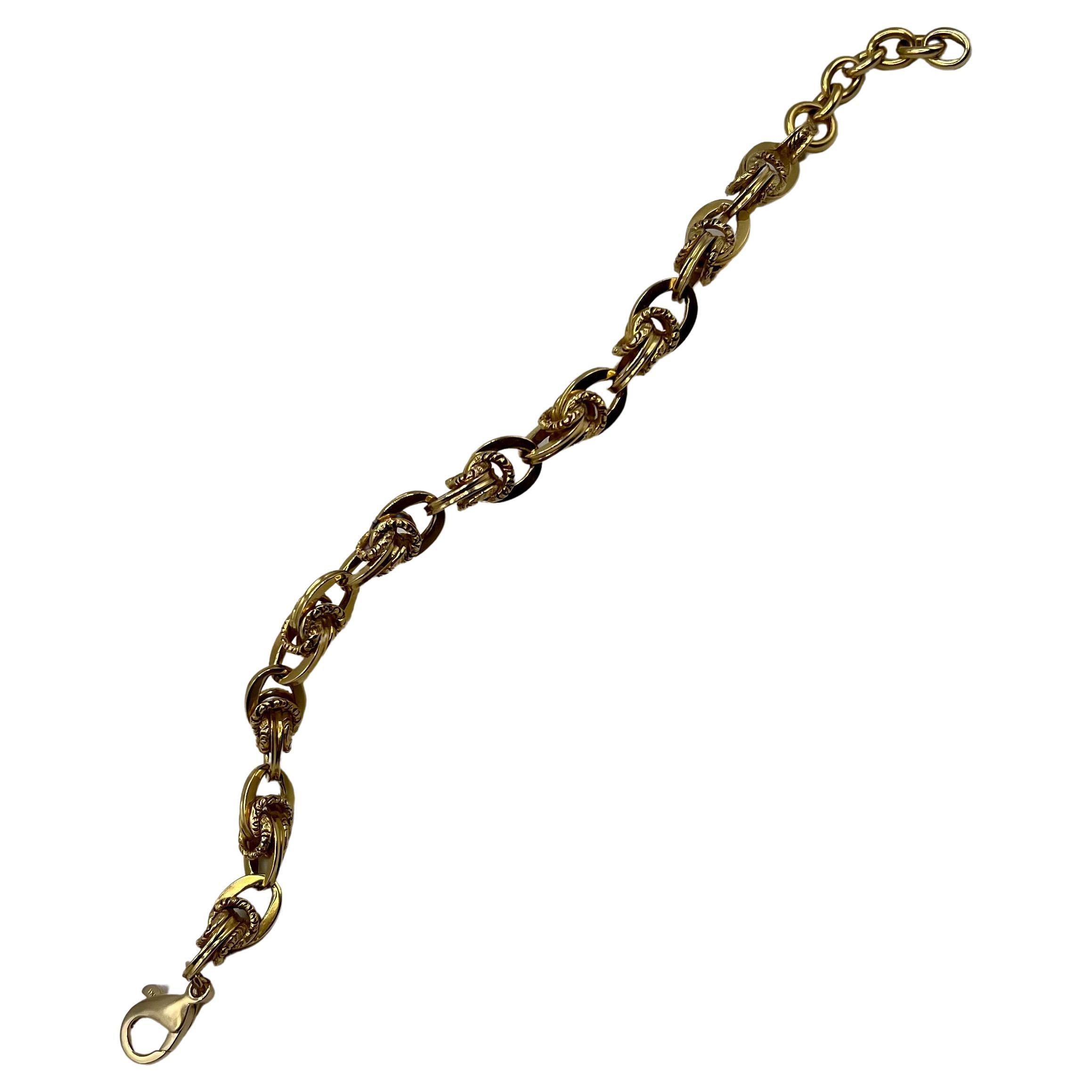 This weighty filigree bracelet has a unique link design. It is a combination of smooth and carved links intertwined. This bracelet is bold enough to stand alone or to layer with a watch or other bracelets. The length is 8 1/4 but can be adjusted